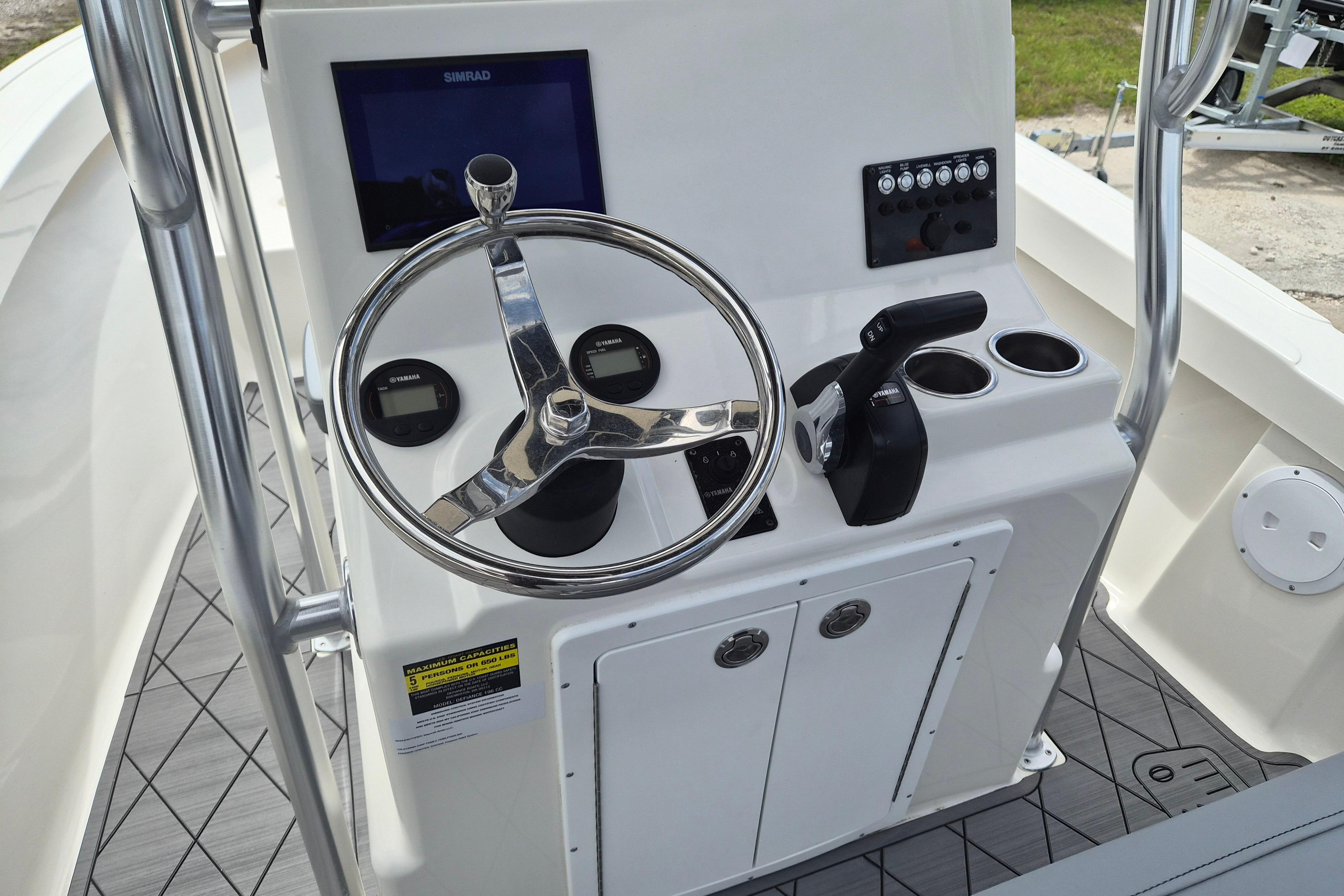 Steering console of 2026 Defiance Catalina 190 boat with controls and display.