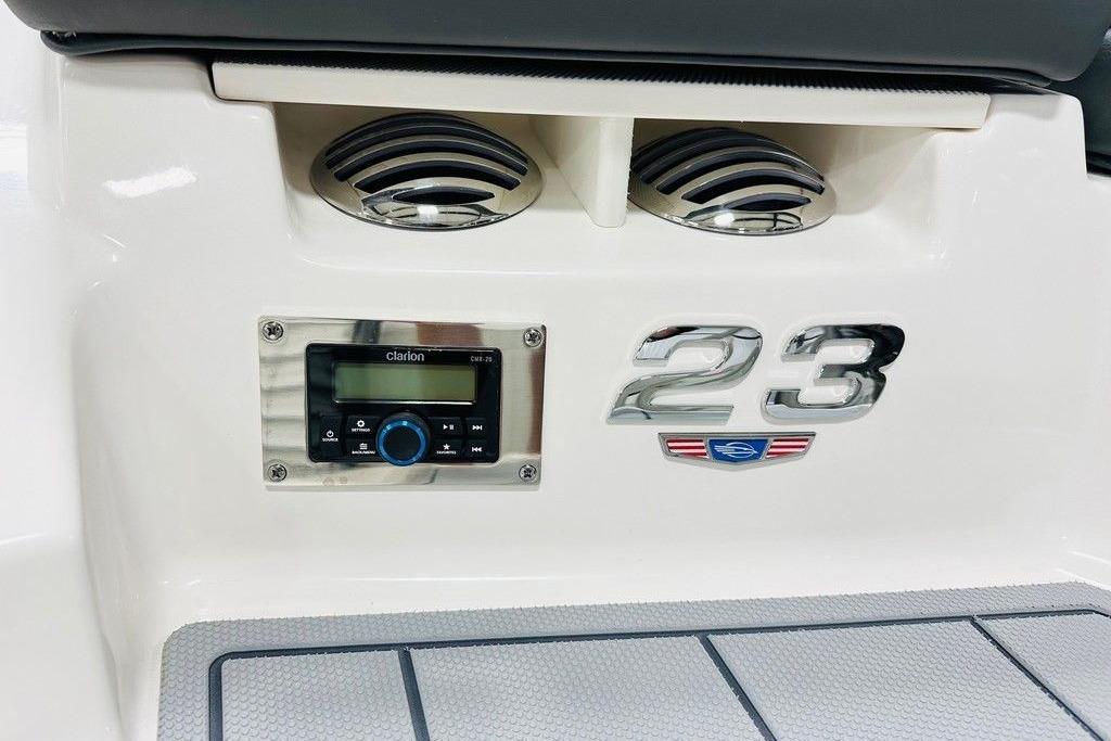 2025 Chaparral 23 SSi OB boat dashboard with stereo system and model emblem.