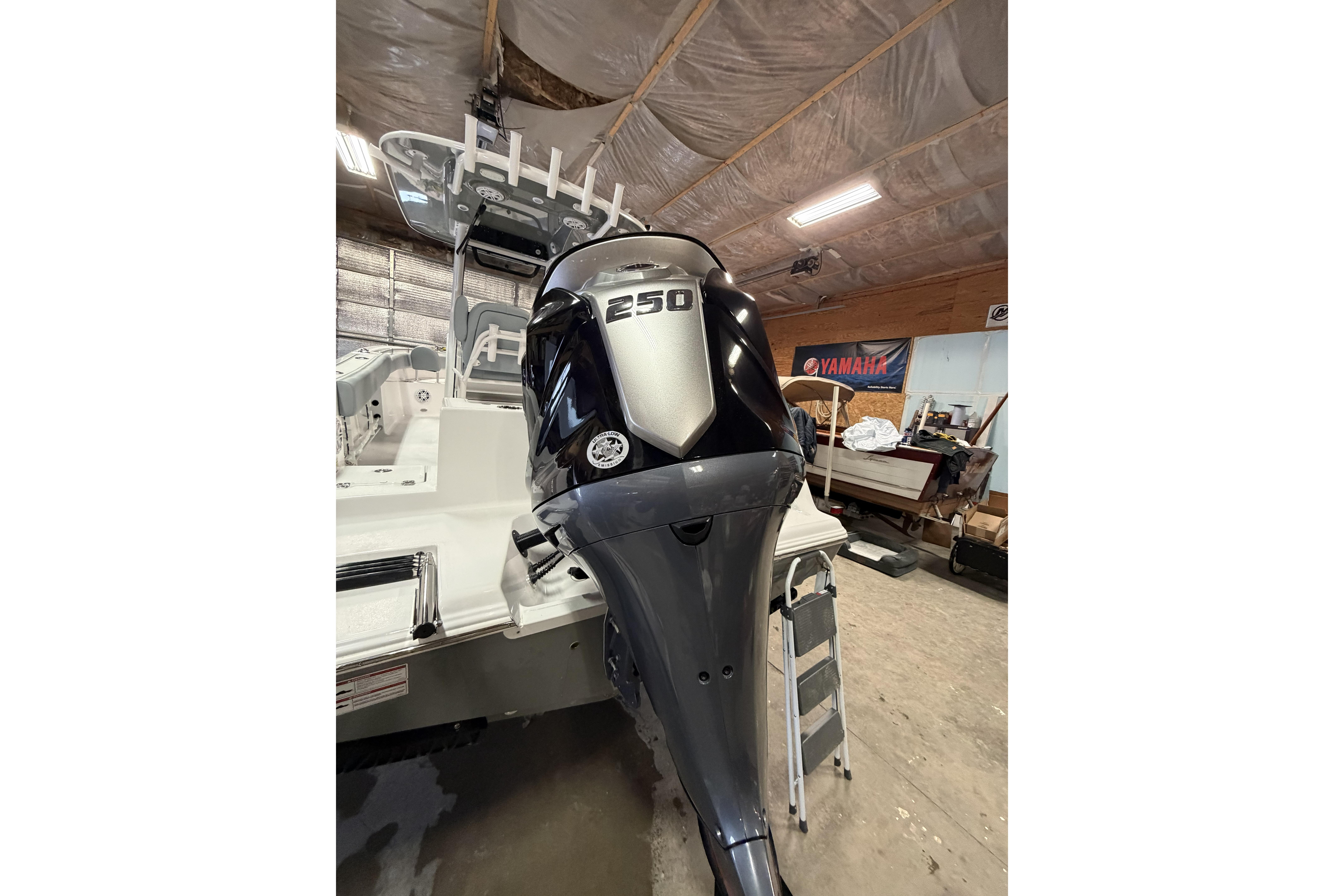 2026 Sportsman Open 232 Center Console with powerful 250 horsepower engine in a garage setting.