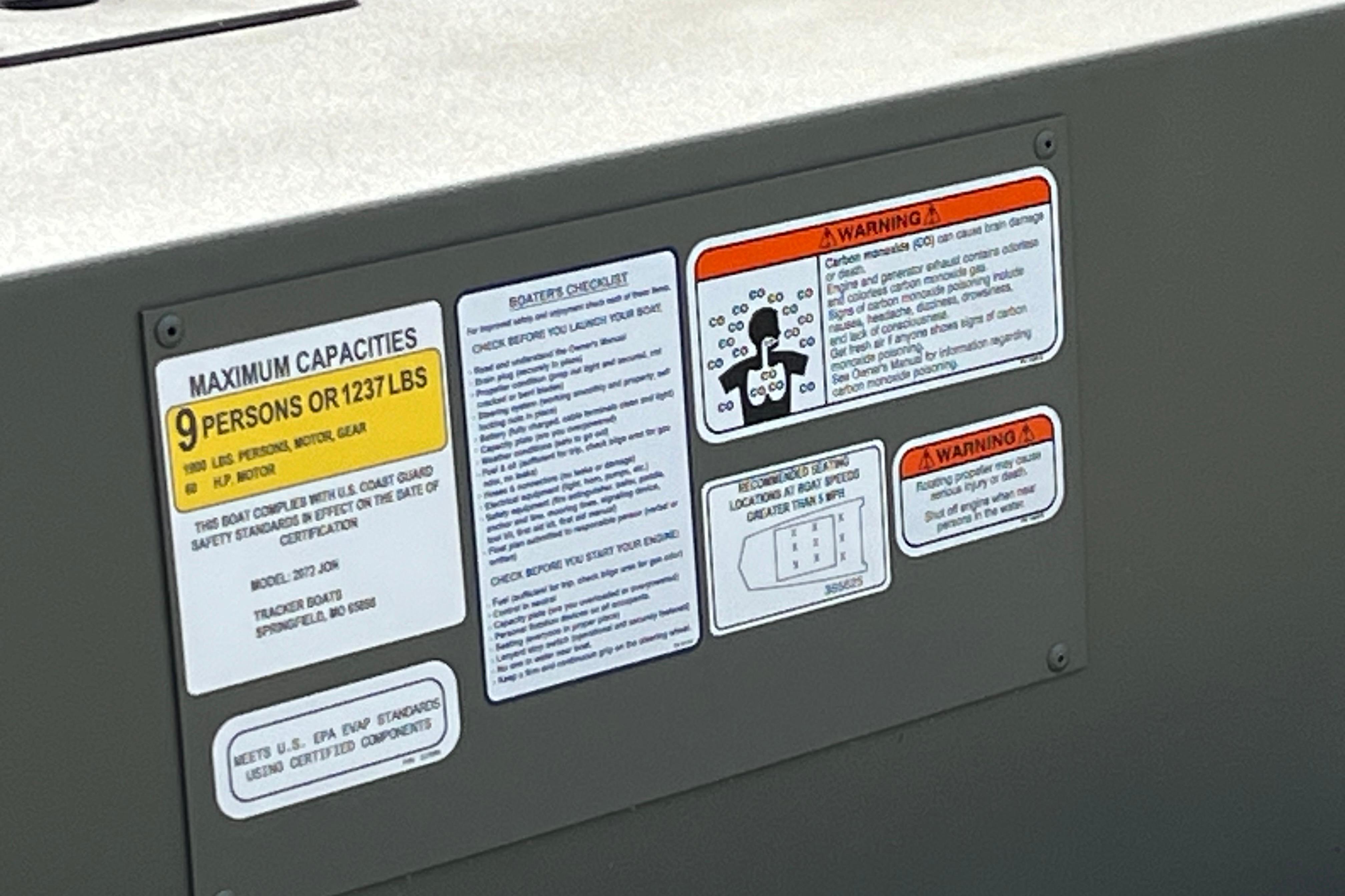 Warning and capacity labels on 2026 Tracker Grizzly 2072 Utility boat.