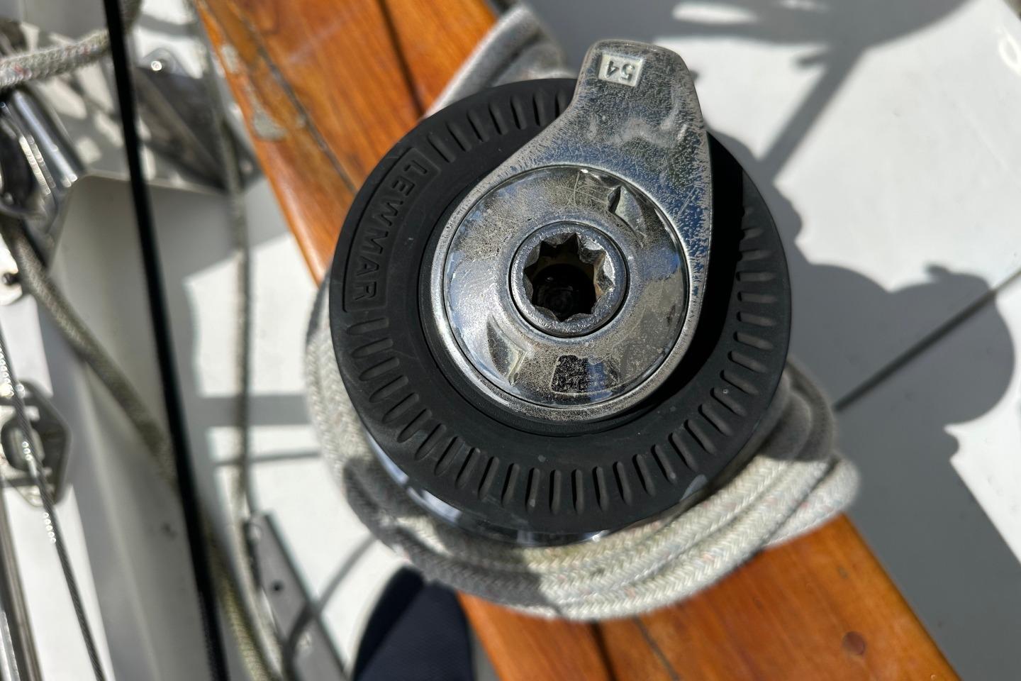 Winch on 1976 Valiant 40 sailboat deck, featuring Lewmar branding and coiled rope.