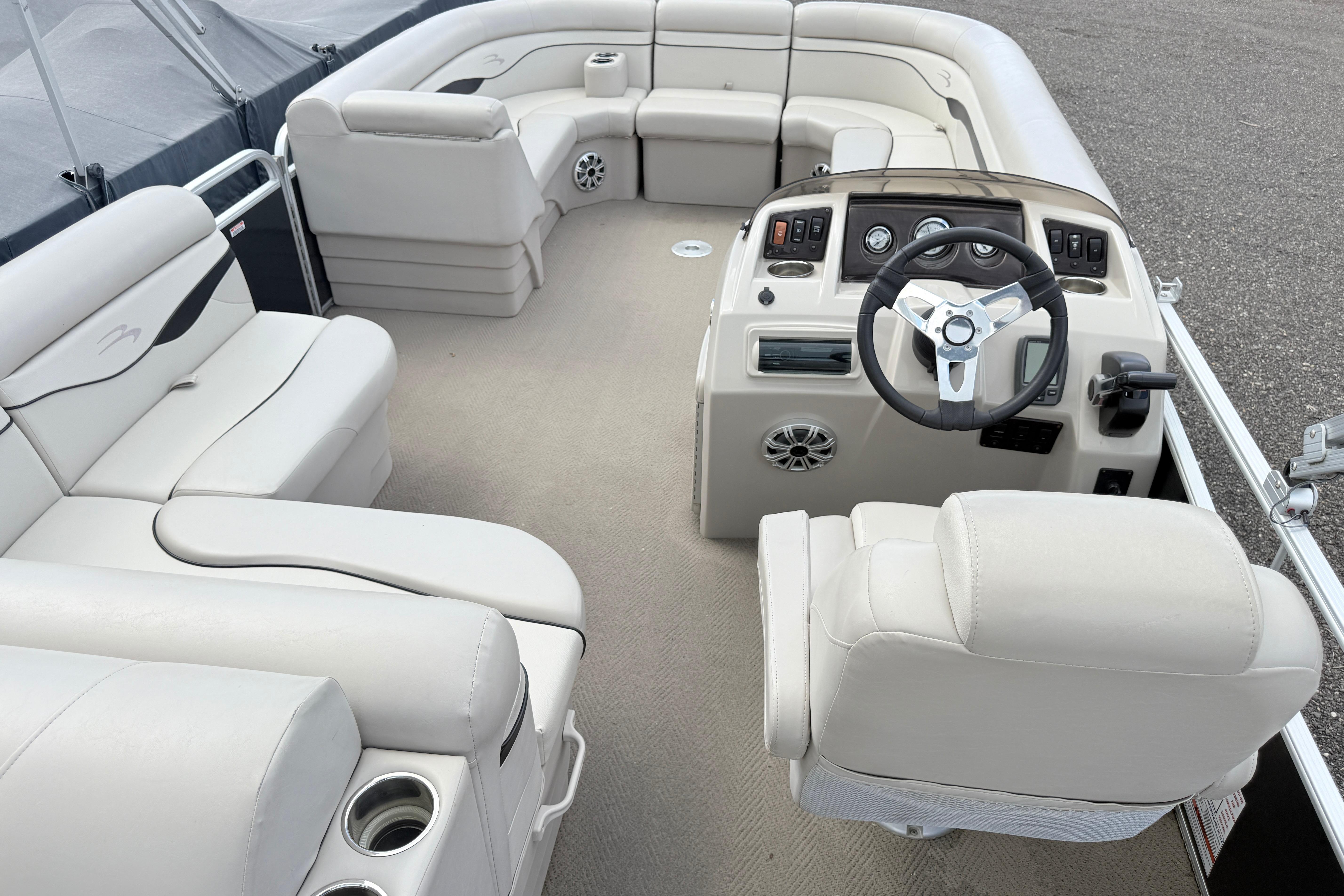 Luxurious interior of a 2015 Bennington 24SSLX pontoon boat with plush seating and modern controls.