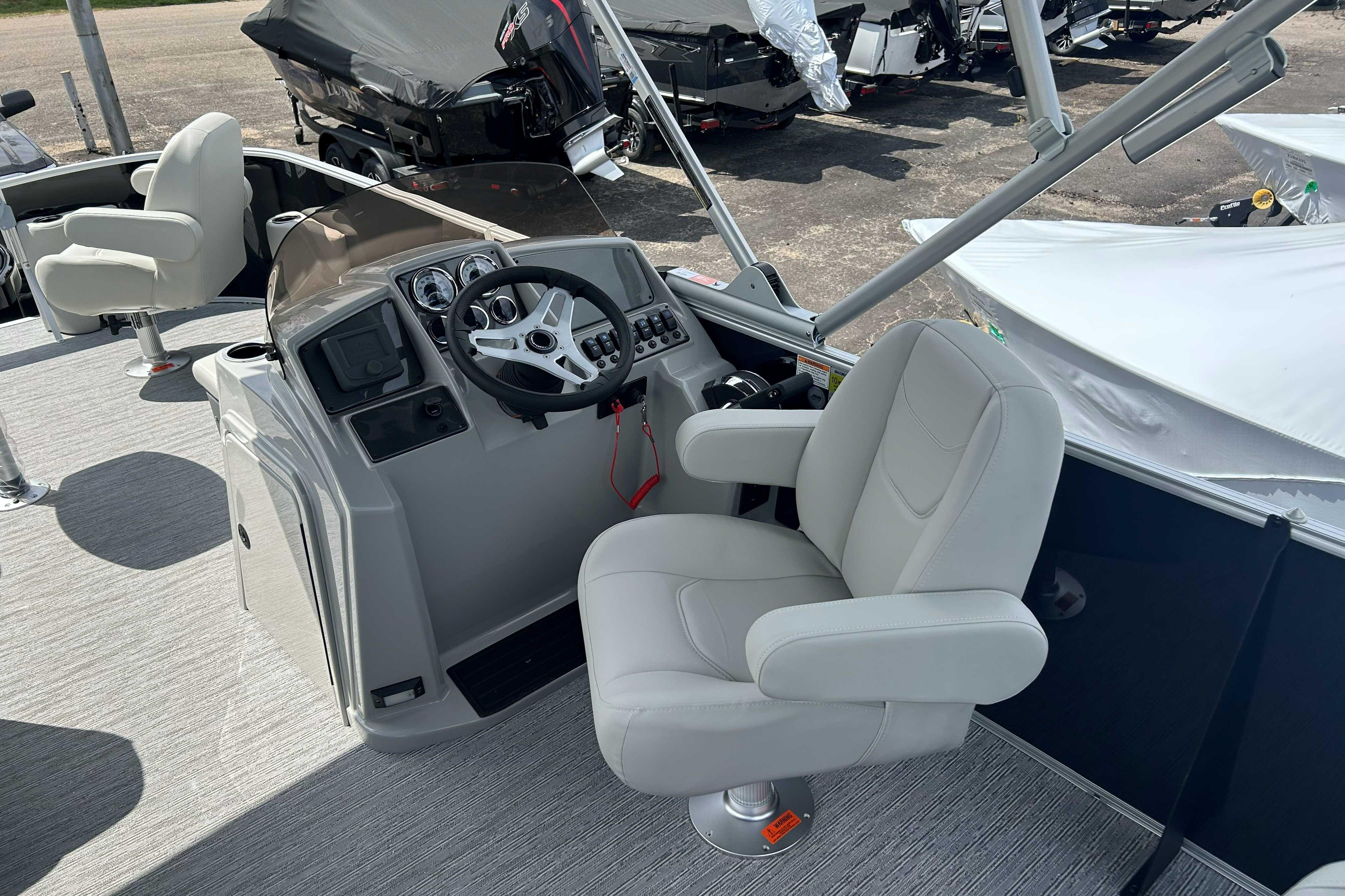 2026 Starcraft EX 22 FD boat interior with steering console and comfortable seating.