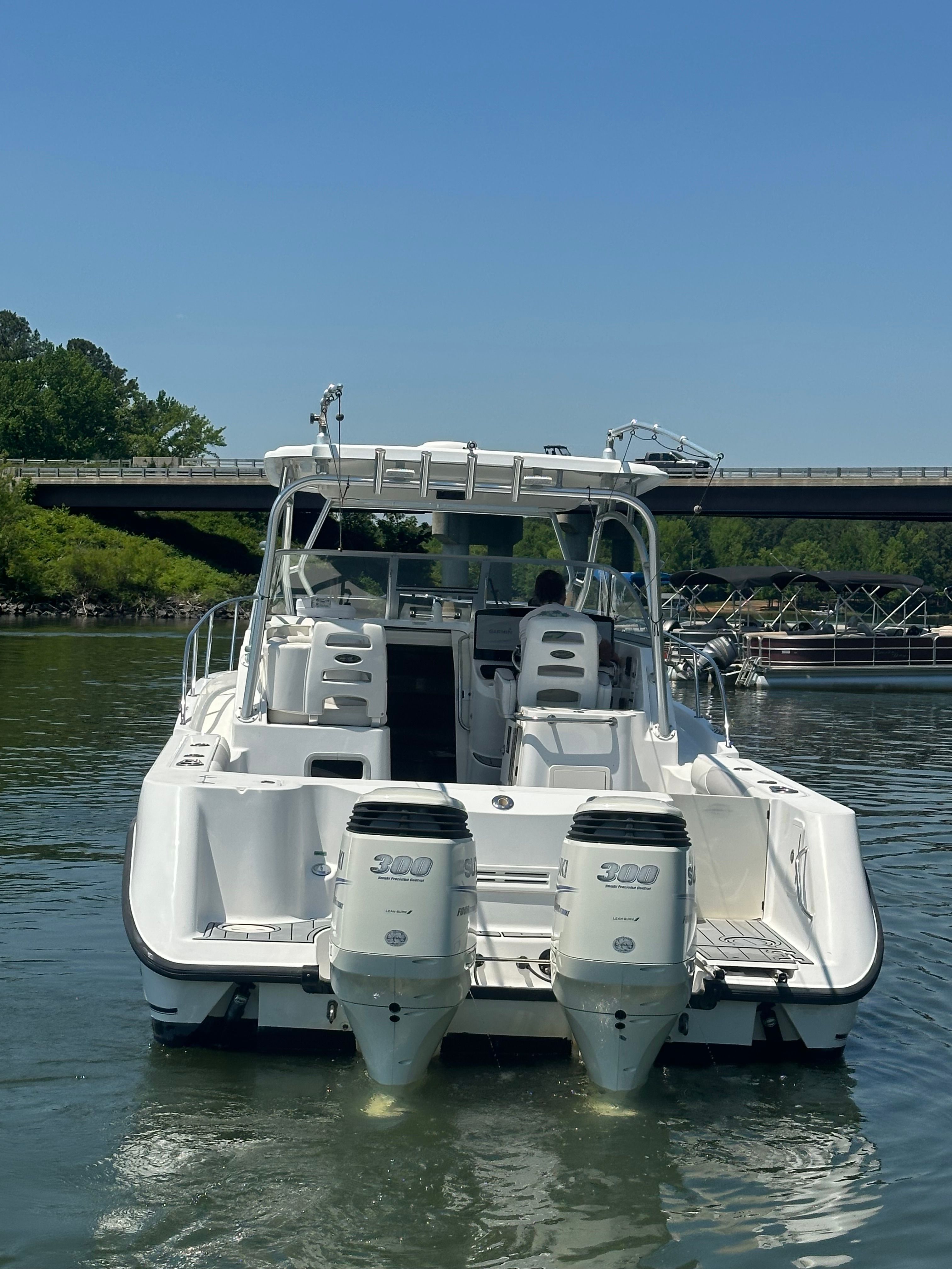 A 2006 Boston Whaler 305 Conquest on the water with twin outboard engines.