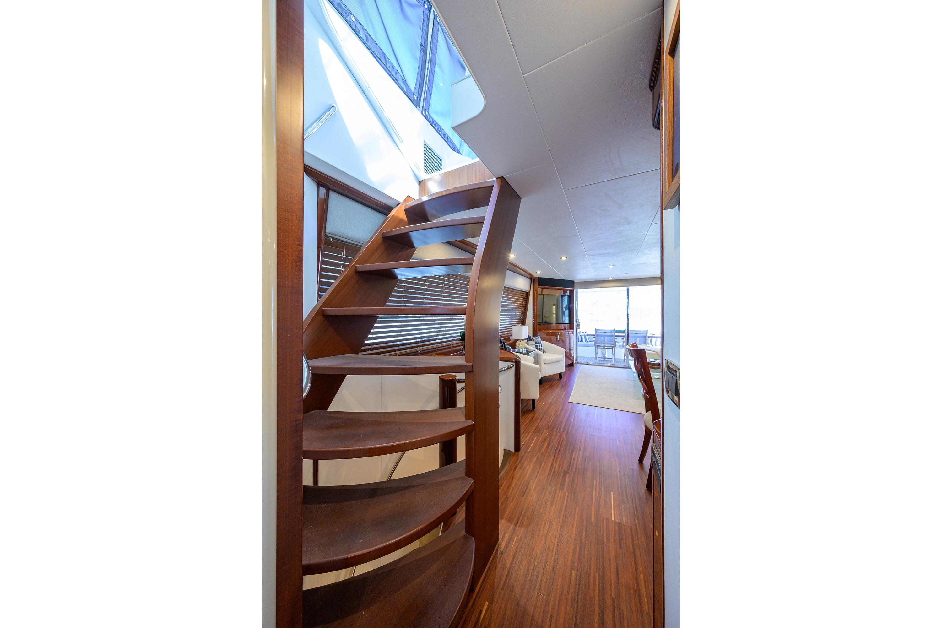 Interior of 2005 Lazzara 68 Enclosed Bridge yacht with wooden staircase and modern design.