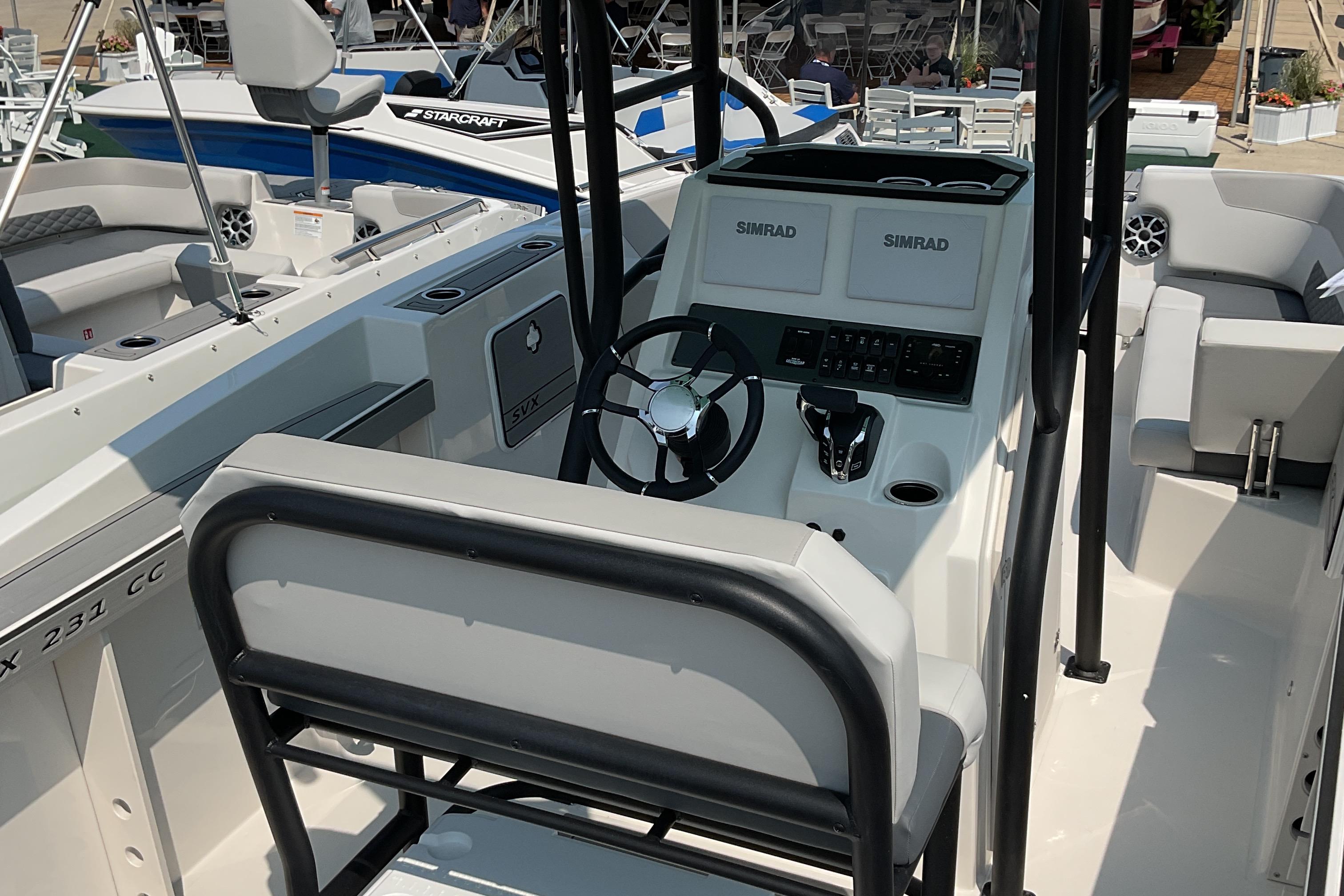 2026 Starcraft SVX 231 OB CC boat interior with steering console and seating.