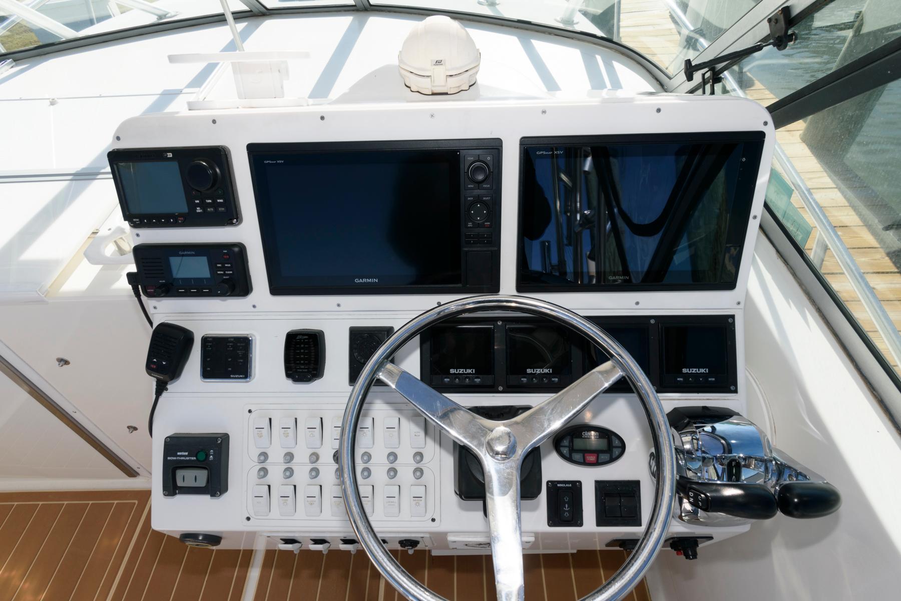 Control panel of 2005 Stamas 320 Express boat with Suzuki 350 repower, featuring modern navigation equipment.