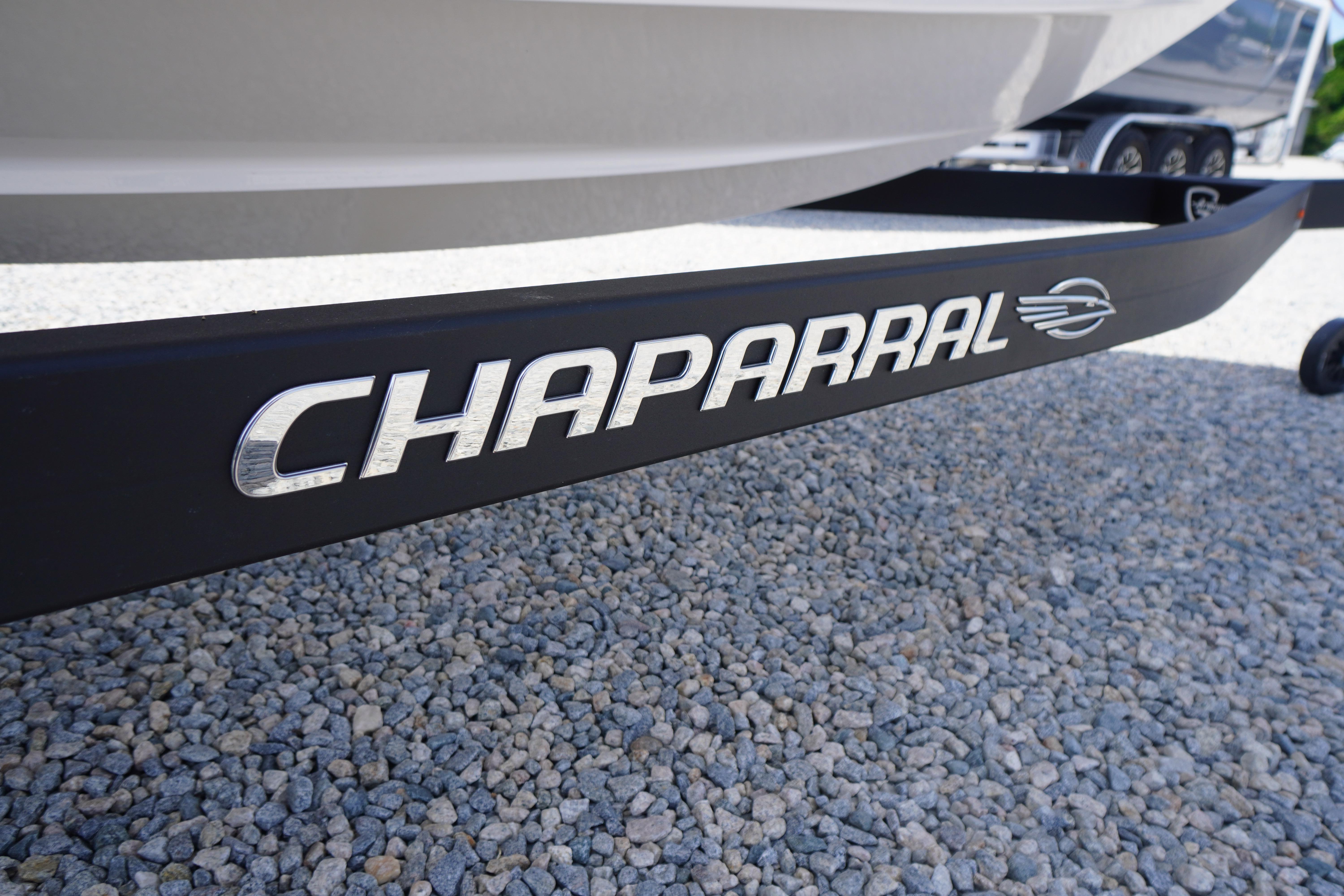 2026 Chaparral 23 SSi OB boat trailer on gravel surface.