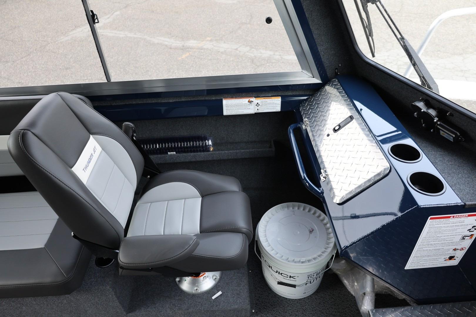 Interior of 2026 Thunder Jet 24 Alexis Pro boat with seating and storage compartments.