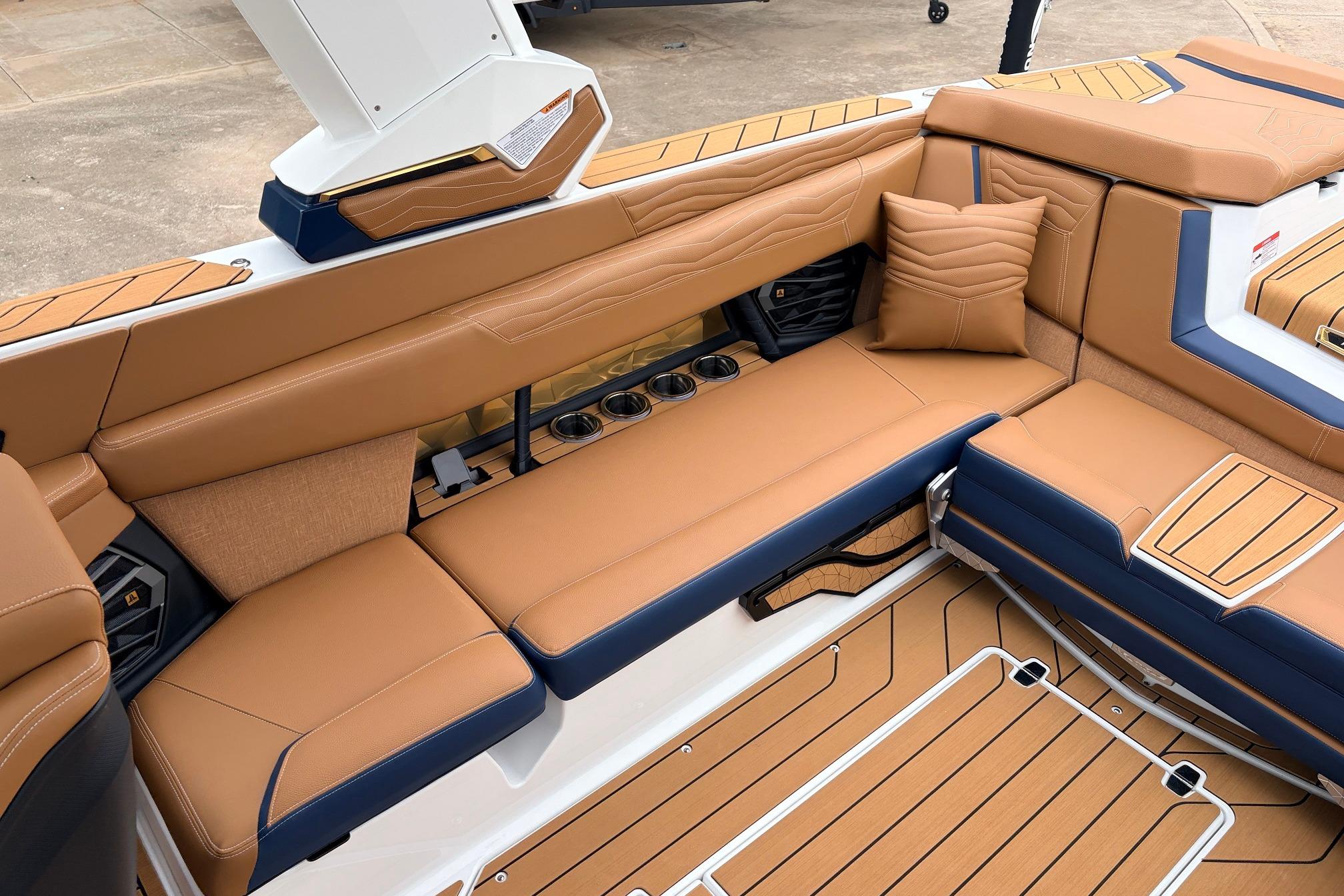 Luxurious interior of 2026 Nautique Super Air Nautique G25 with tan seating and cup holders.