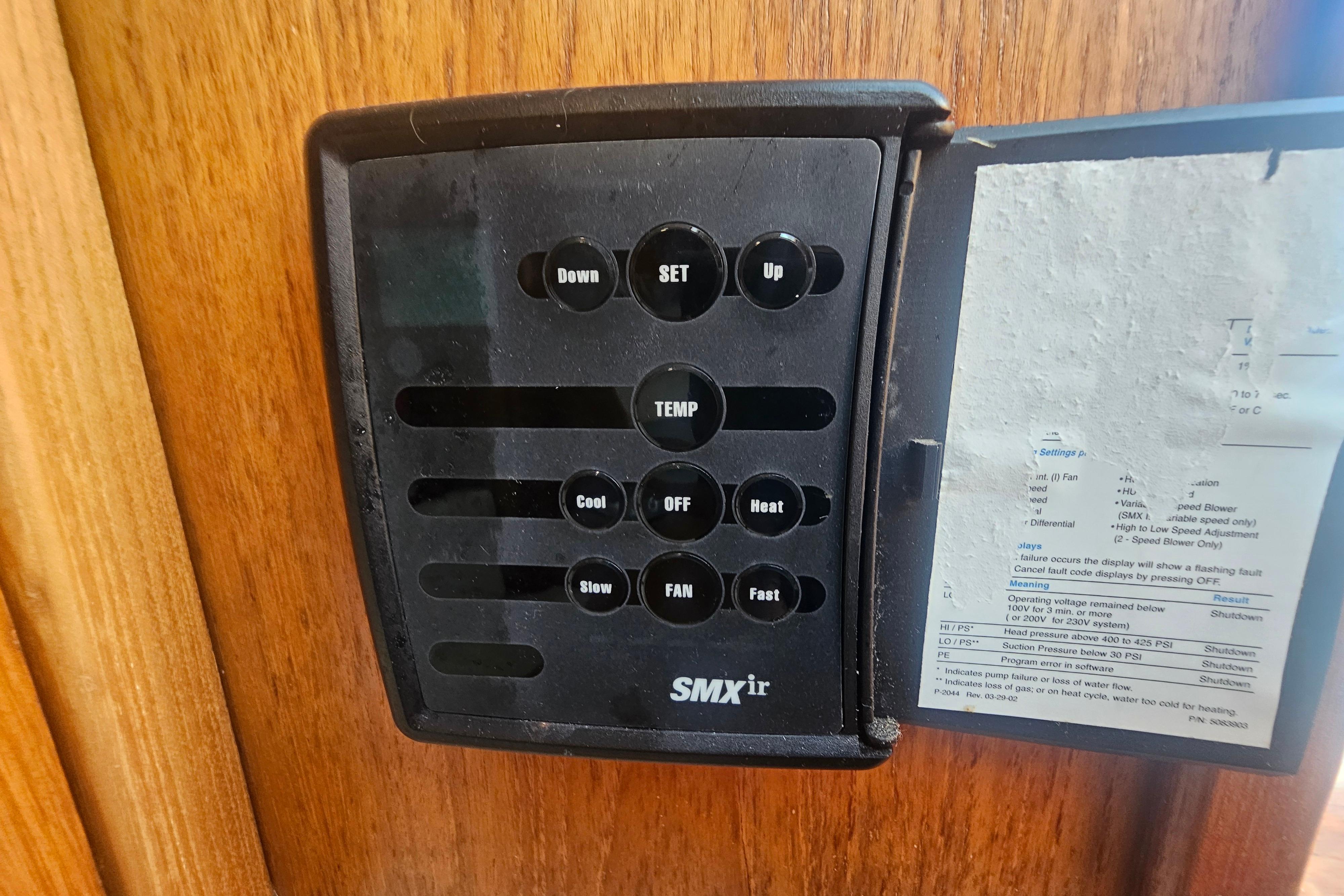 SMXir control panel on 2003 Topaz 32 Express boat, mounted on wooden surface.