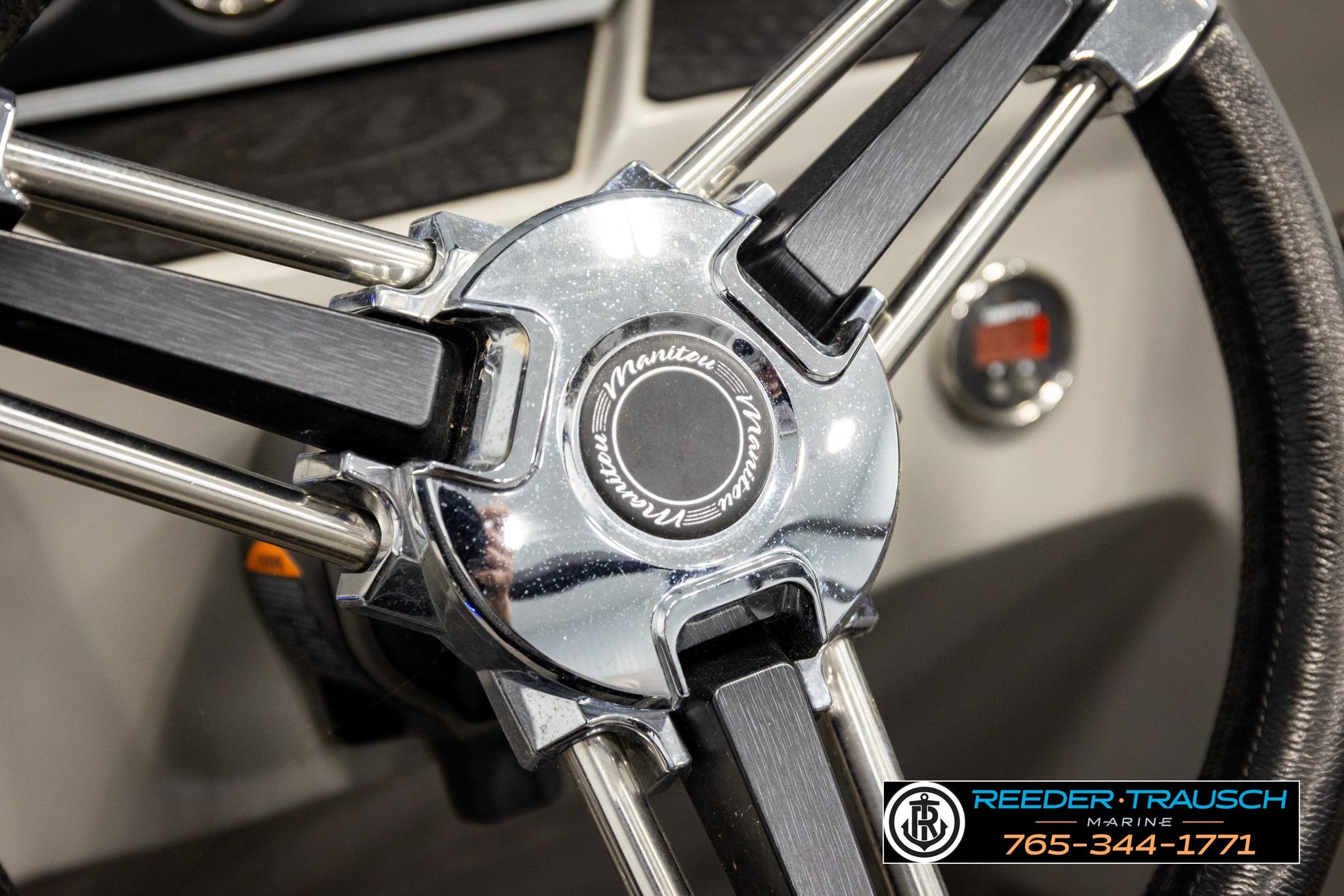 Steering wheel of 2019 Manitou Oasis SR VP boat, featuring chrome and black accents.