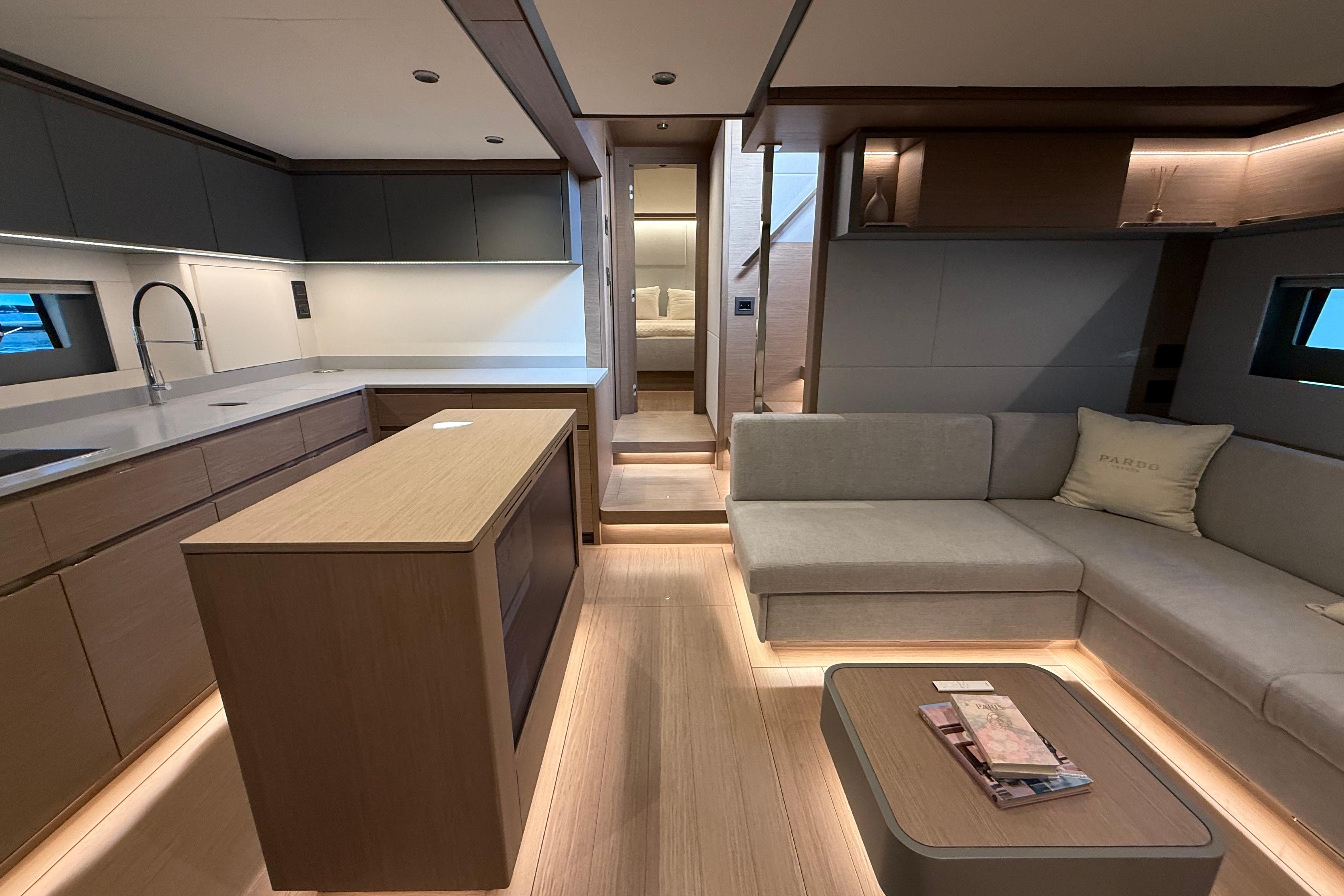 Luxurious interior of 2026 Pardo Yachts GT75, featuring modern kitchen and cozy seating area.