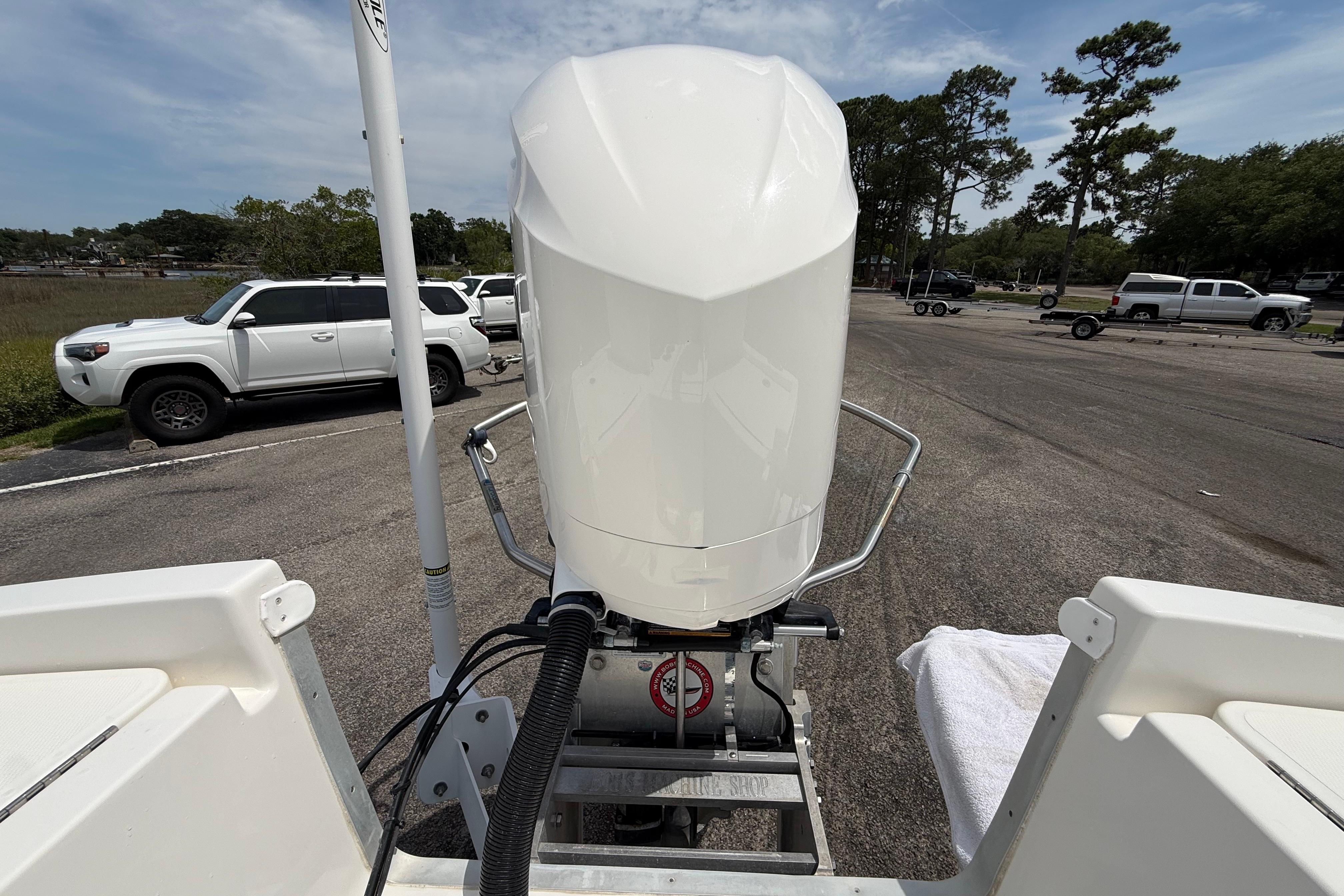 2019 Regulator 26XO boat engine view at a parking area with vehicles.