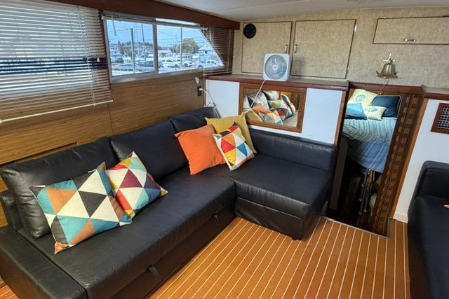 Interior of 1980 Chris-Craft 381 Catalina yacht with modern seating and colorful pillows.