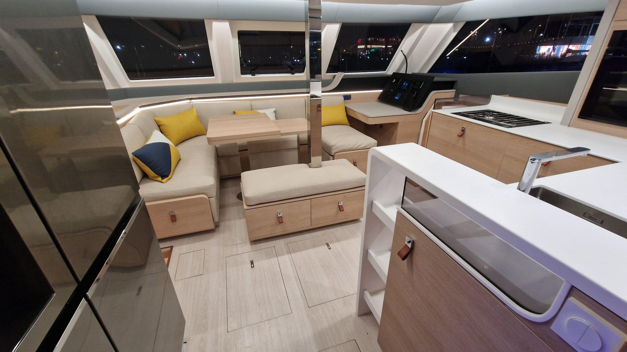 Modern interior of 2026 Aventura 45 yacht with sleek kitchen and cozy seating area.