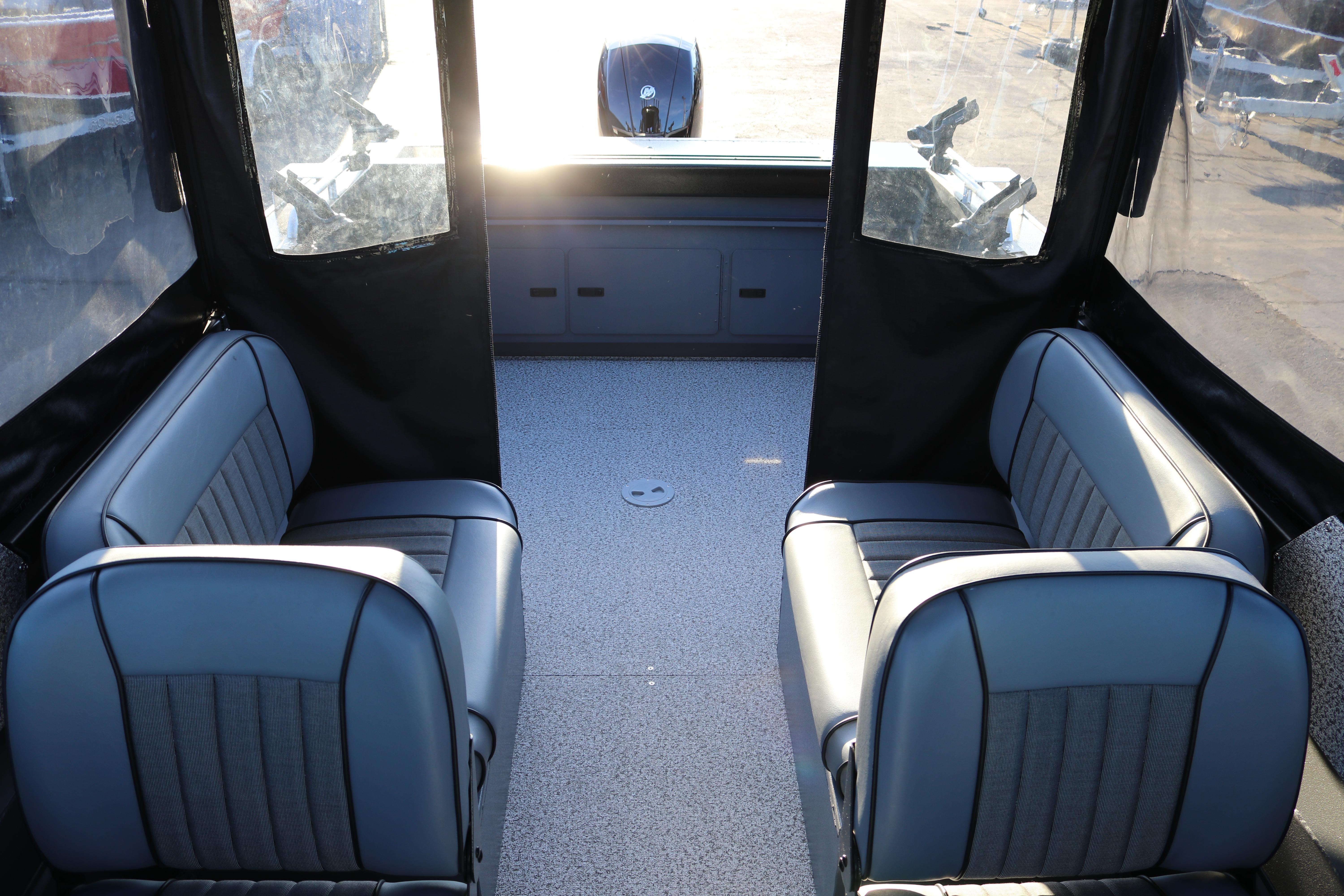 Interior of 2026 Alumaweld Stryker X202 boat with gray seating and spacious layout.