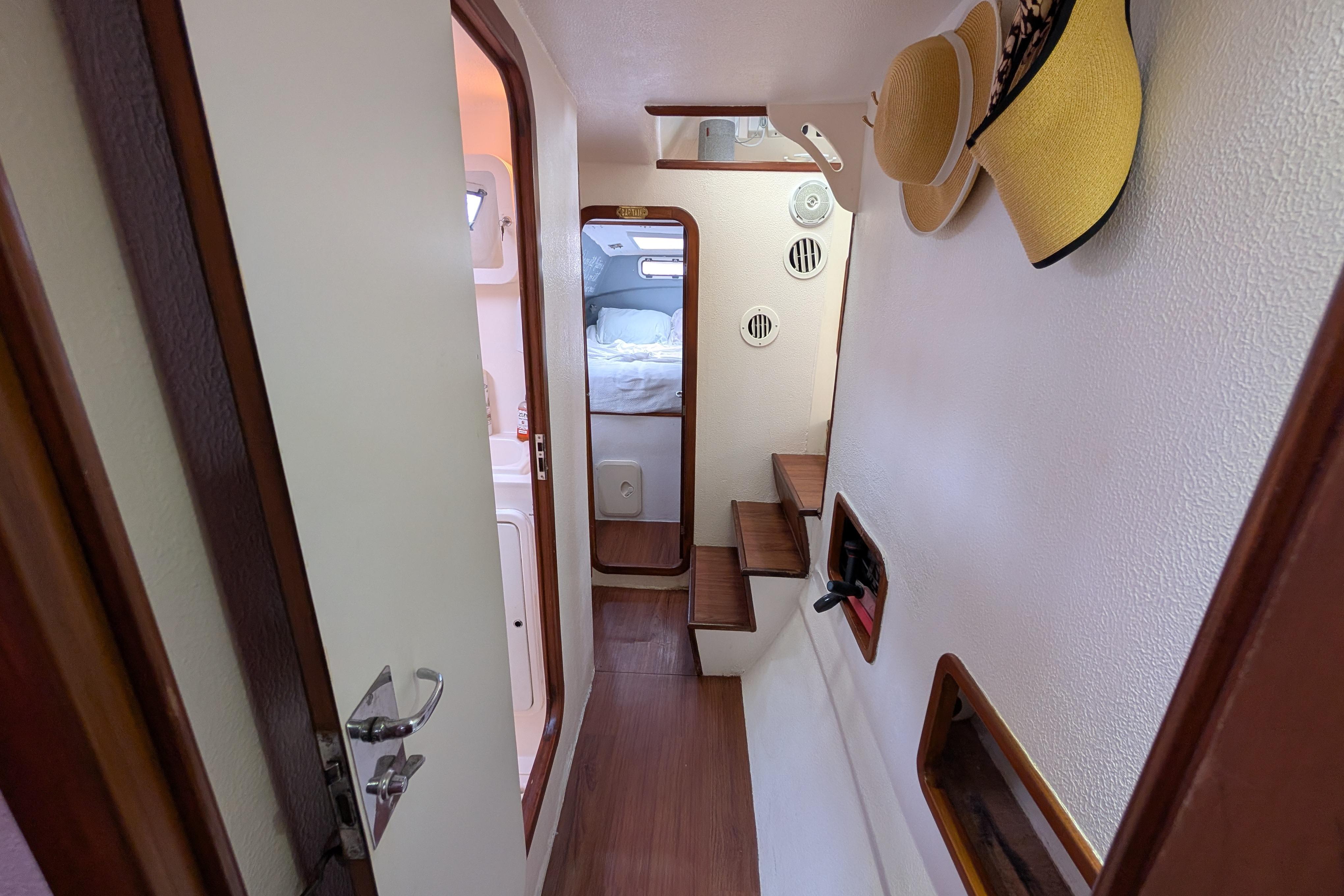 Interior of 1999 Island Spirit 37 yacht, featuring cozy cabin and wooden accents.