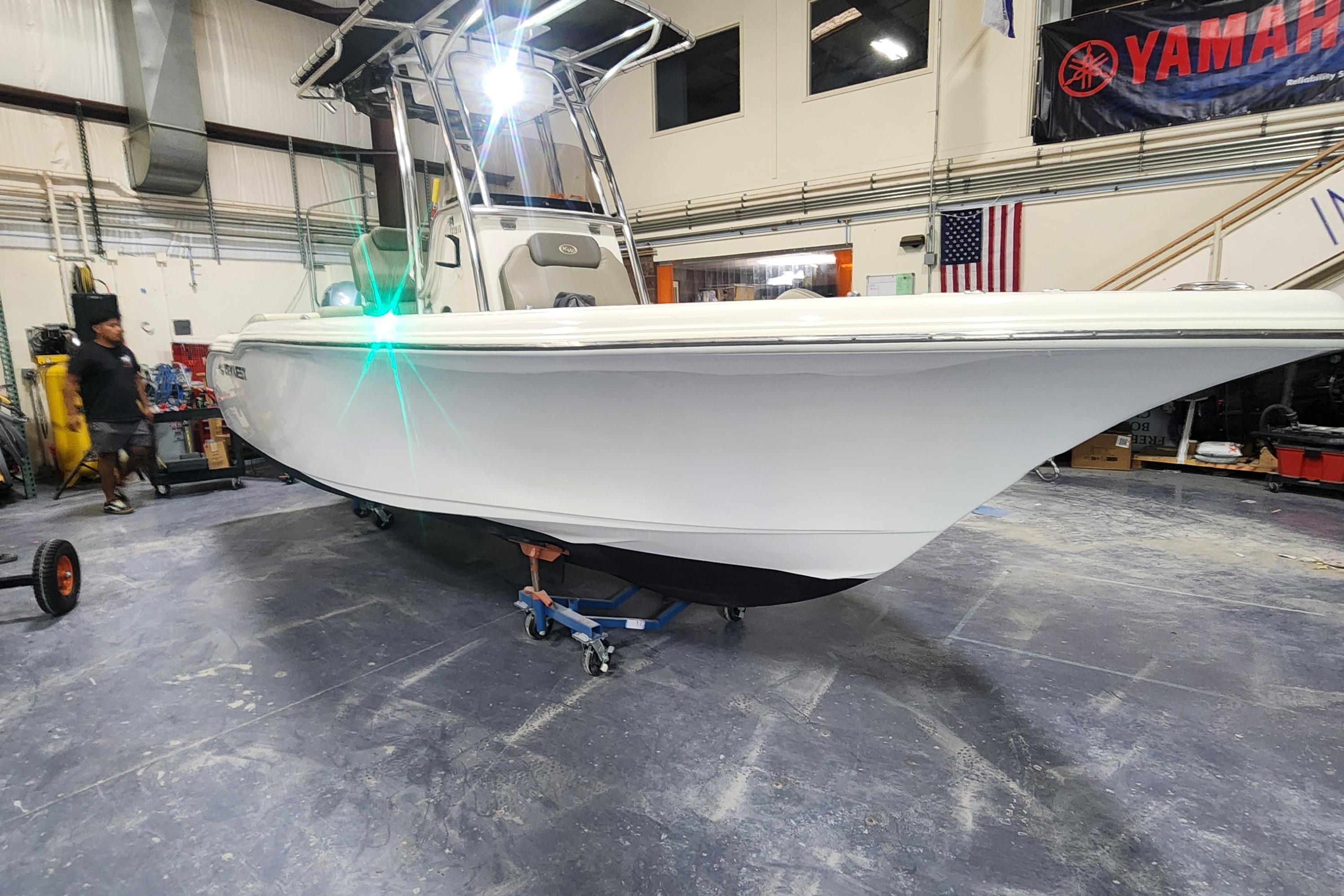 2023 Key West 219 FS boat in a workshop, featuring sleek design and modern equipment.