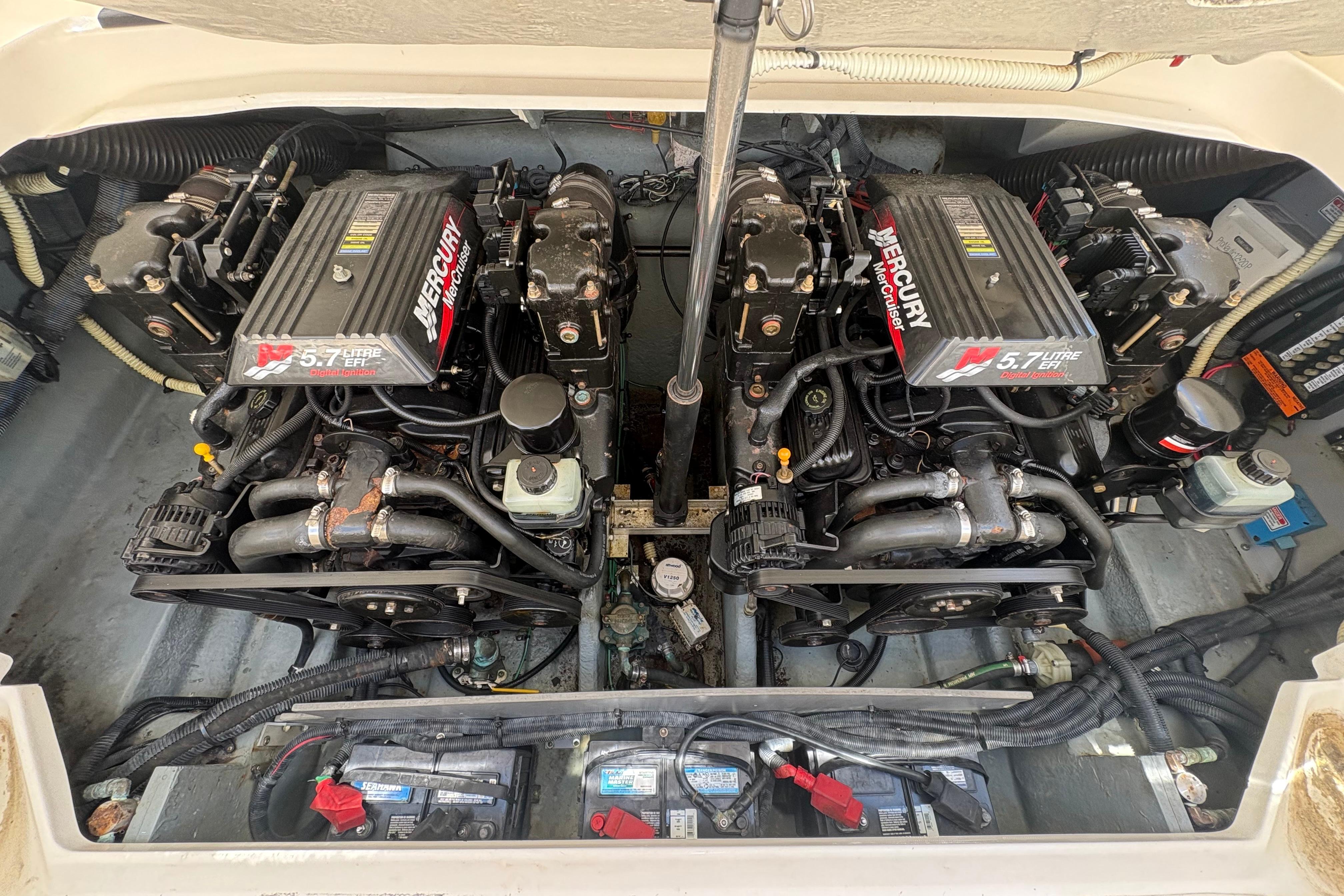 Twin Mercury engines in a 2001 Sea Ray 290 Sun Sport boat engine compartment.