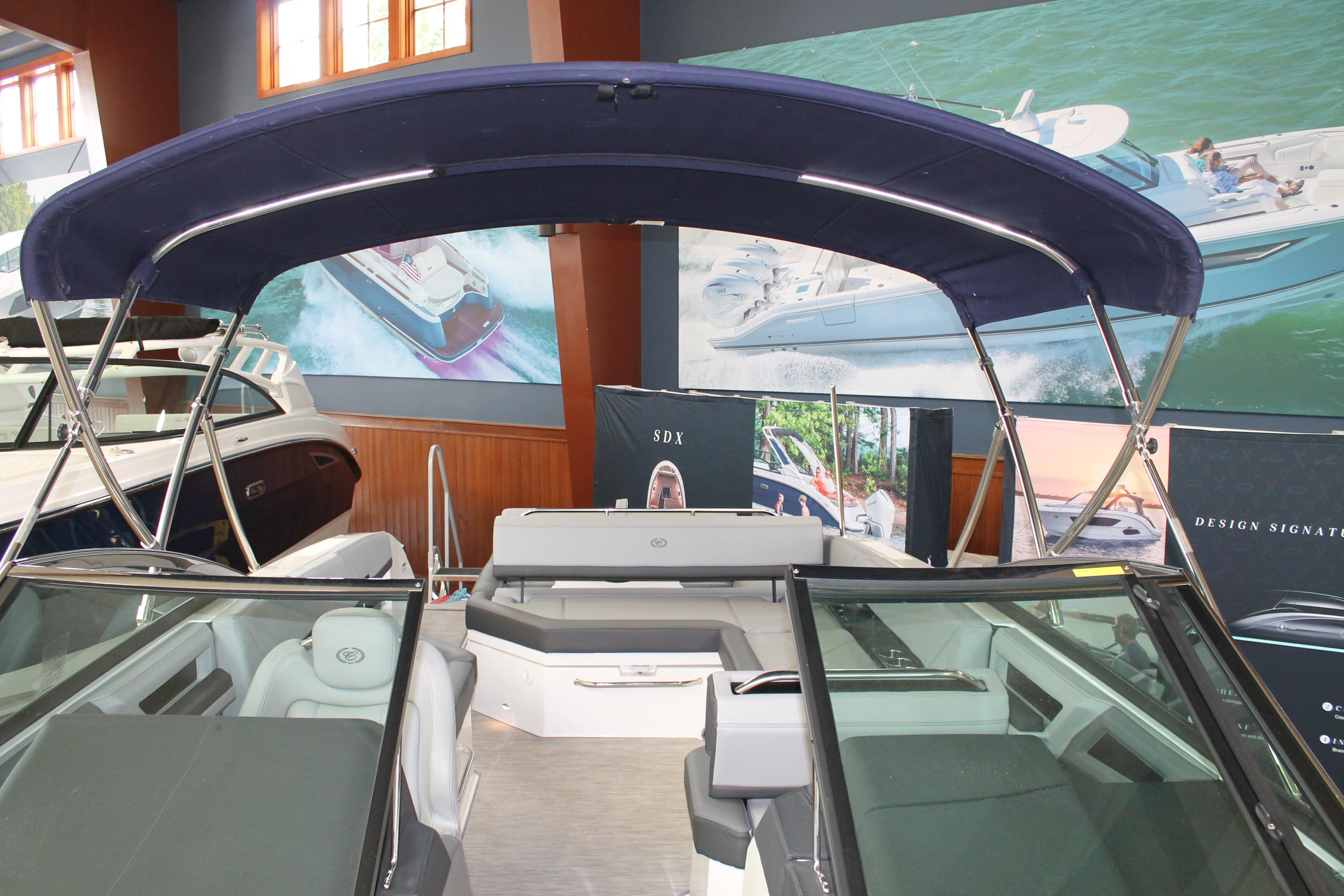 2023 Cobalt R8 boat interior with blue canopy, displayed in showroom setting.