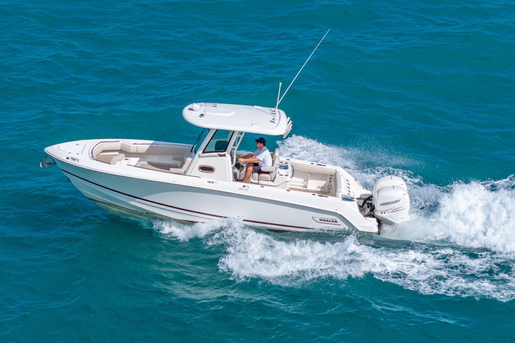2016 Boston Whaler 280 Outrage cruising on clear blue water.