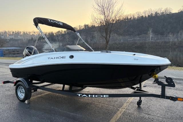 2026 Tahoe T16 boat on trailer, parked outdoors near a lake at sunset.
