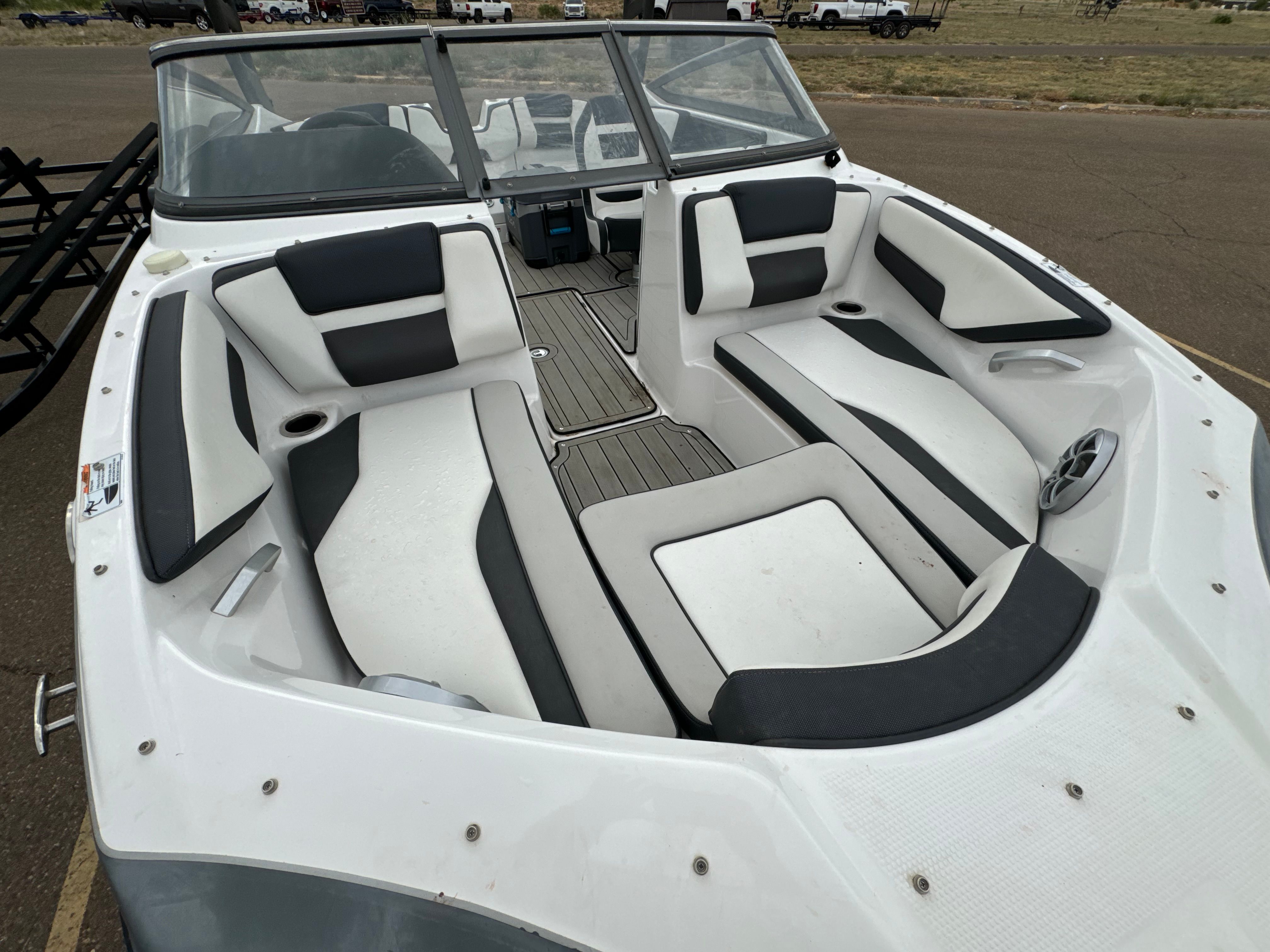 The image shows the cockpit of a 2020 Yamaha Boats 195S with white and black seating.