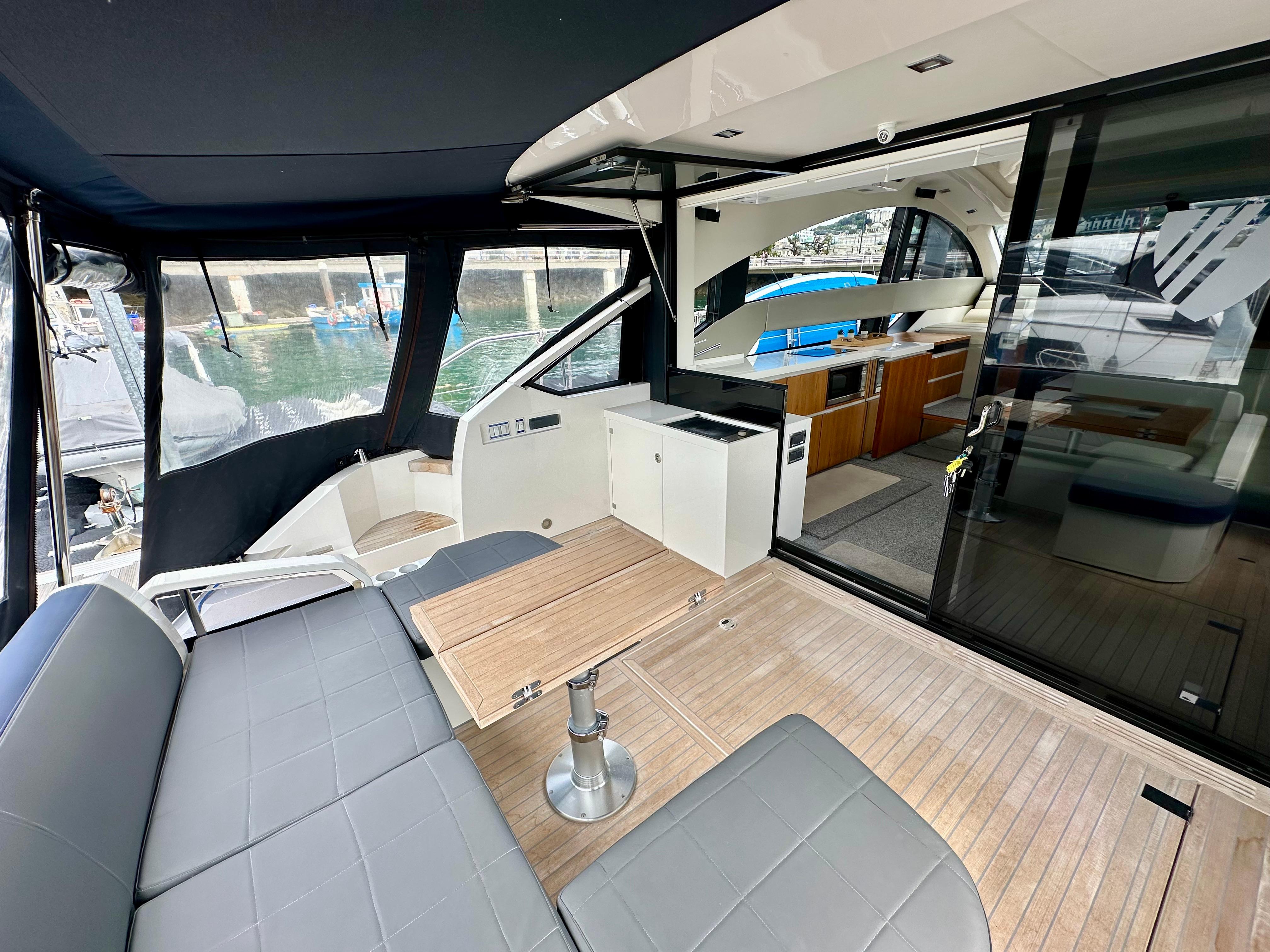 Interior view of 2012 Fairline Targa 50 GT yacht, featuring seating and kitchenette.