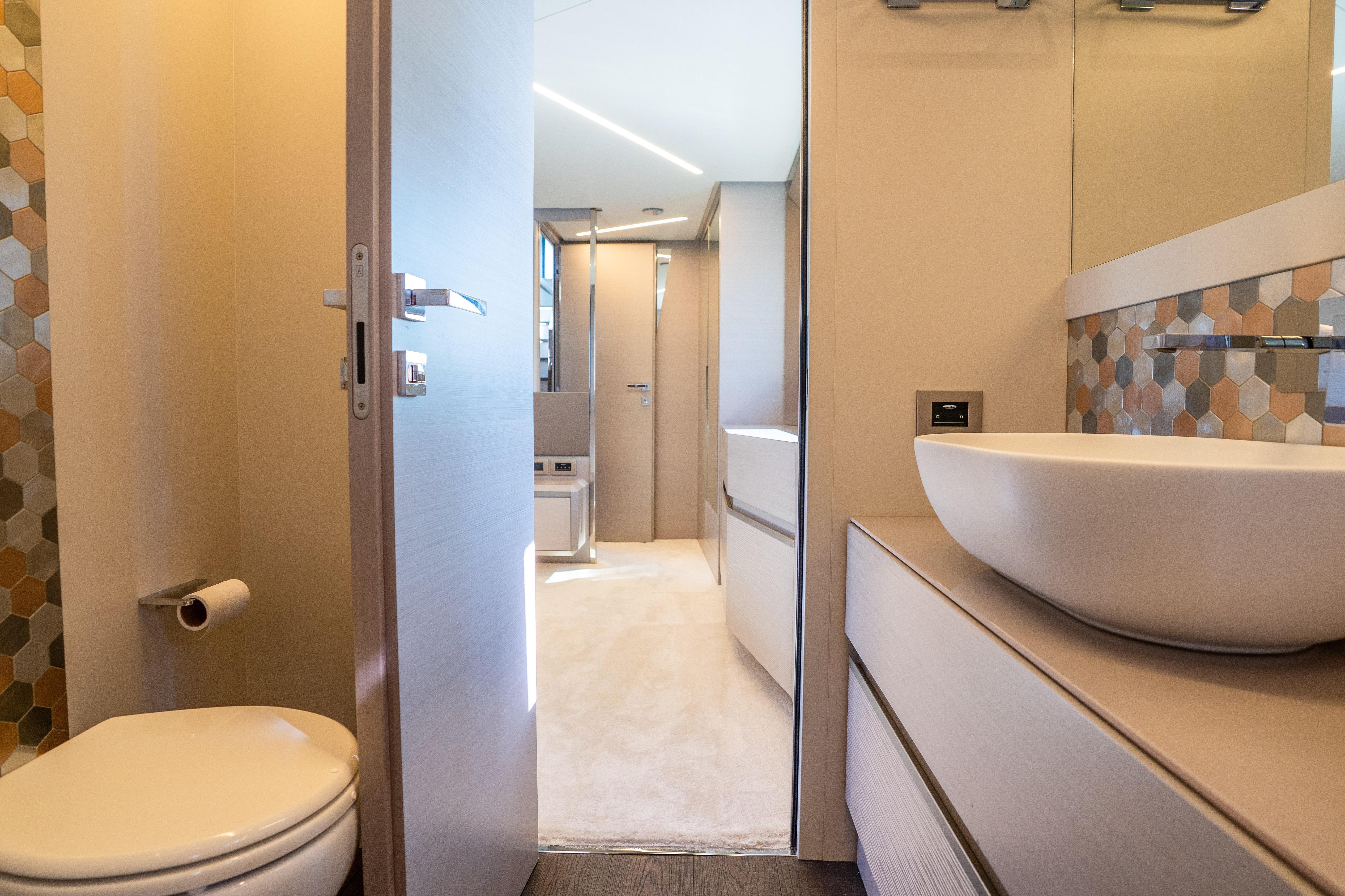 Luxurious bathroom interior of 2024 Pershing 7X yacht with modern fixtures and elegant design.