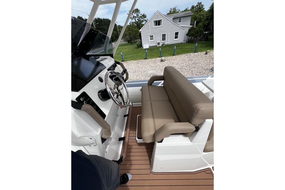 2022 Brig Eagle 8 boat interior with steering wheel and cushioned seating.