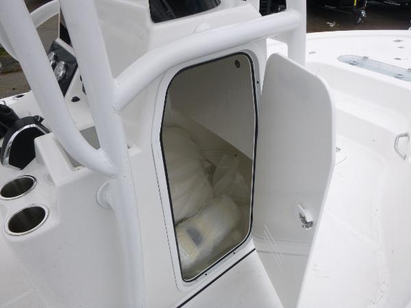 2025 Sea Pro 250 Bay boat storage compartment with open door.