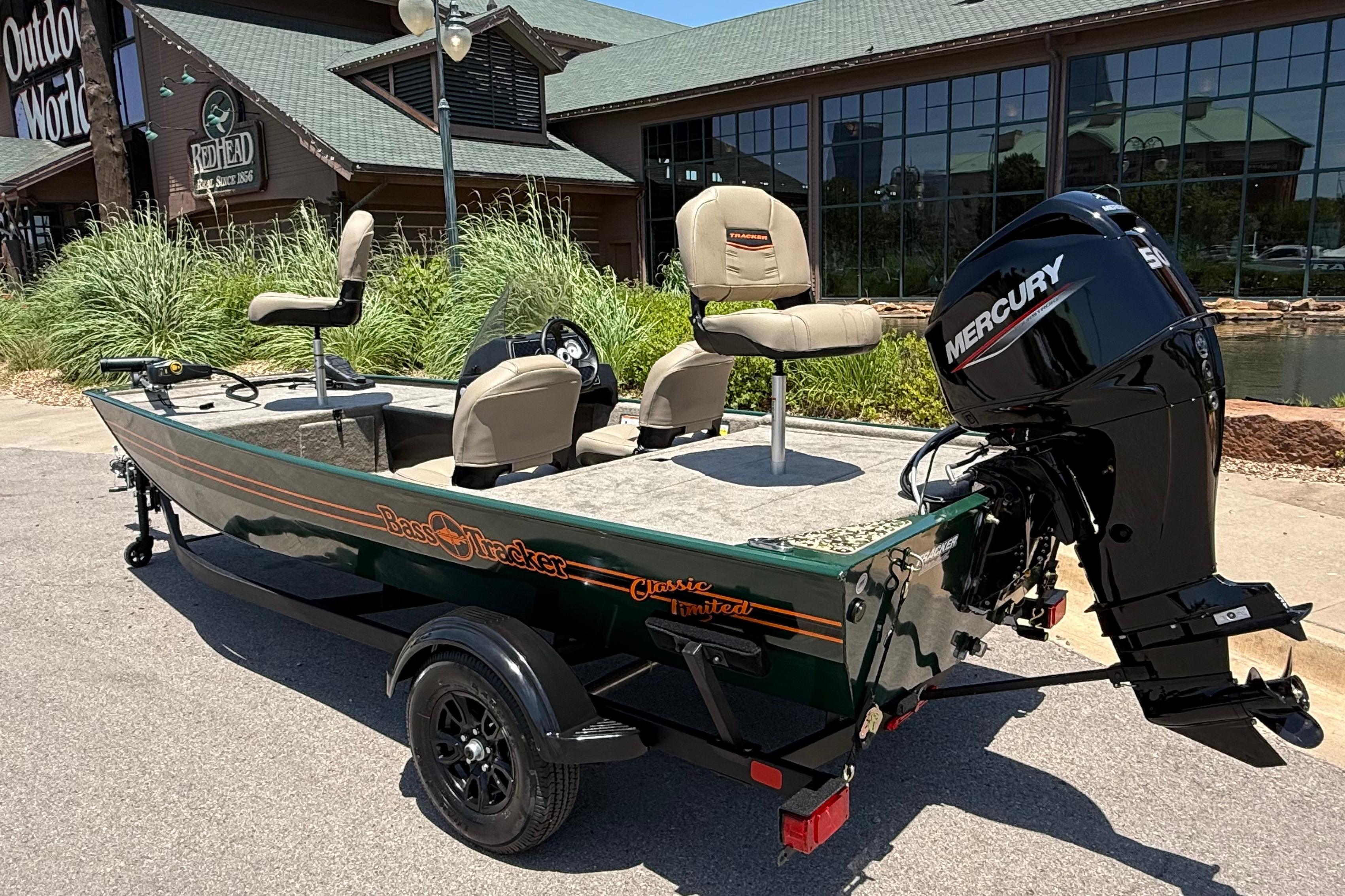 2026 Tracker Bass Tracker Classic Limited boat with Mercury engine outside a store.