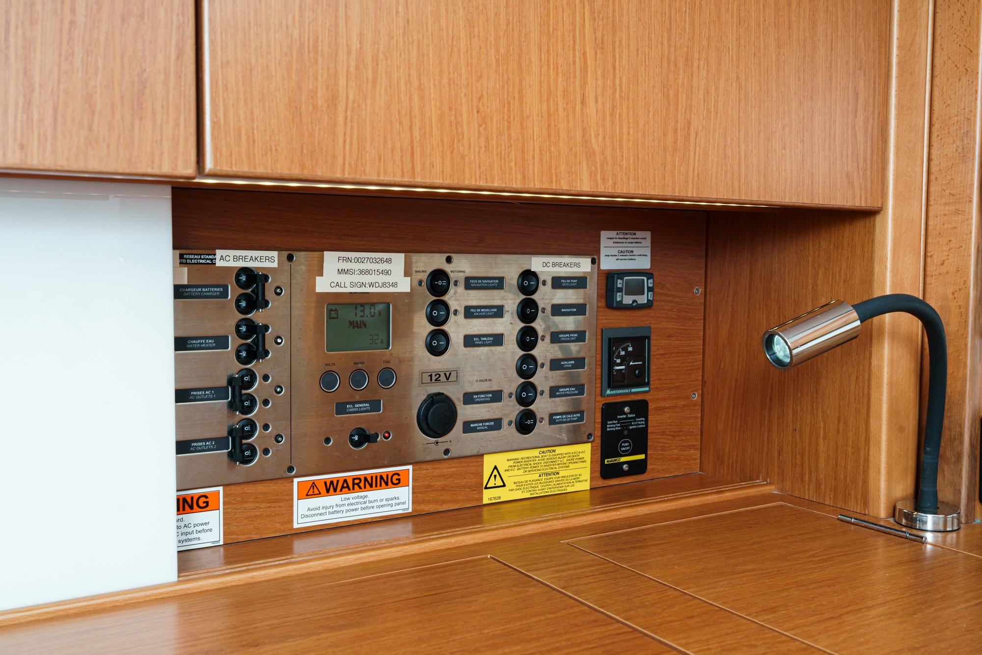 Electrical control panel on a 2017 Beneteau Sense 50 yacht, featuring AC and DC breakers.