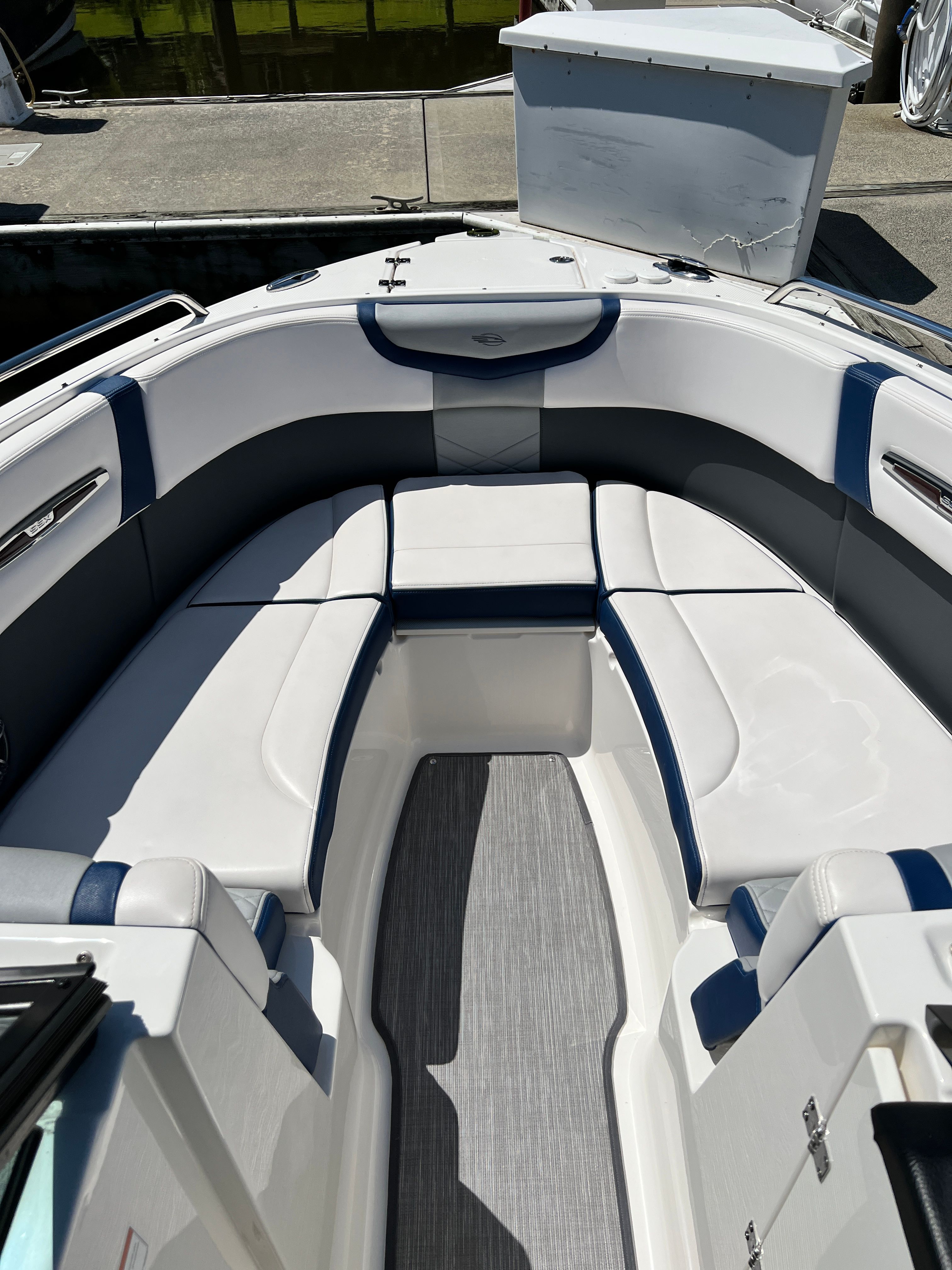 Interior of a 2020 Chaparral 256 SSX boat with white and blue seating.