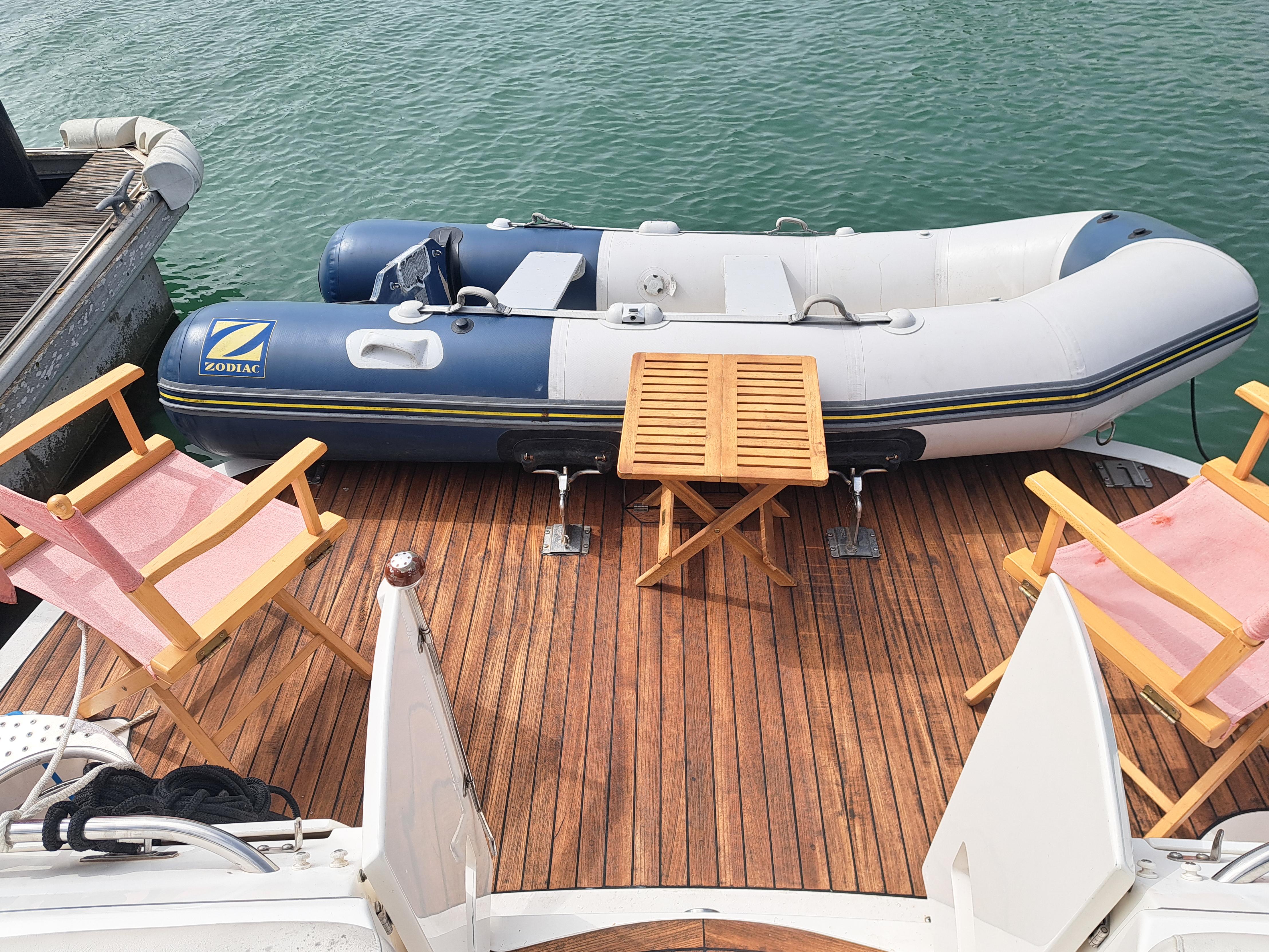 2007 Doral Boca Grande yacht with inflatable boat and deck chairs.