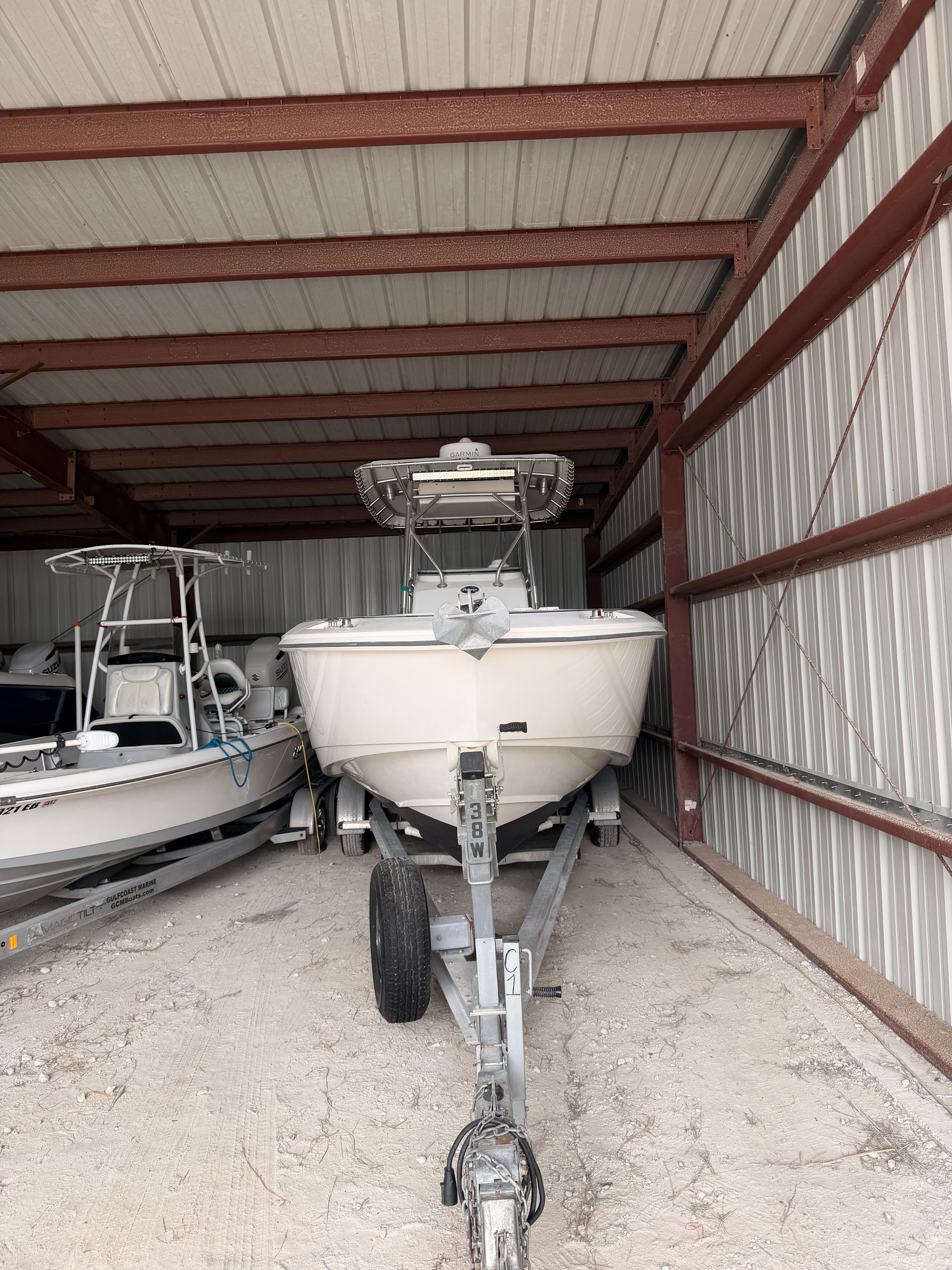 2002 Boston Whaler Outrage 270 parked in storage facility.