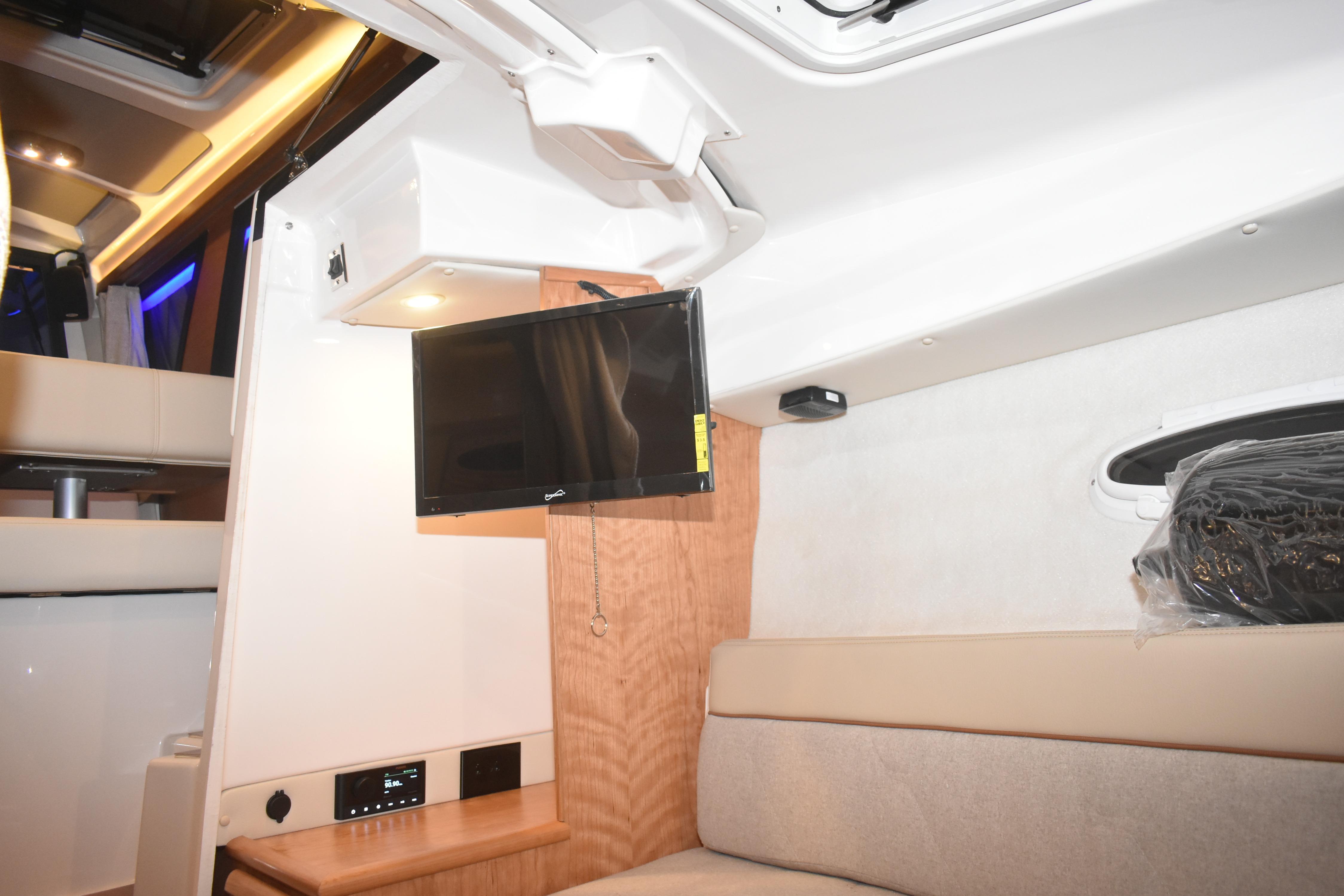 2026 Cutwater C-248 Coupe interior with TV, modern lighting, and comfortable seating.