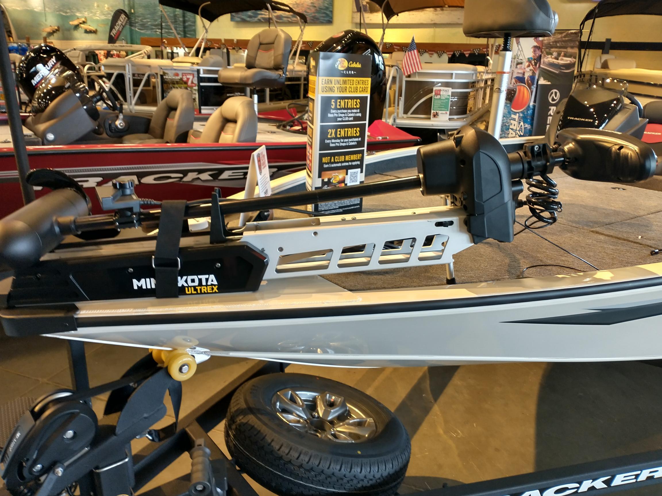 2025 Tracker Savage 215 boat with Minn Kota Ultrex motor displayed indoors.
