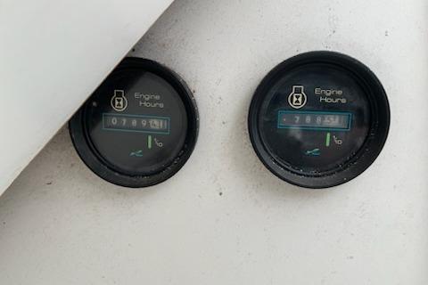 Close-up of engine hour meters on a 1989 Sea Ray 300 Sundancer boat.