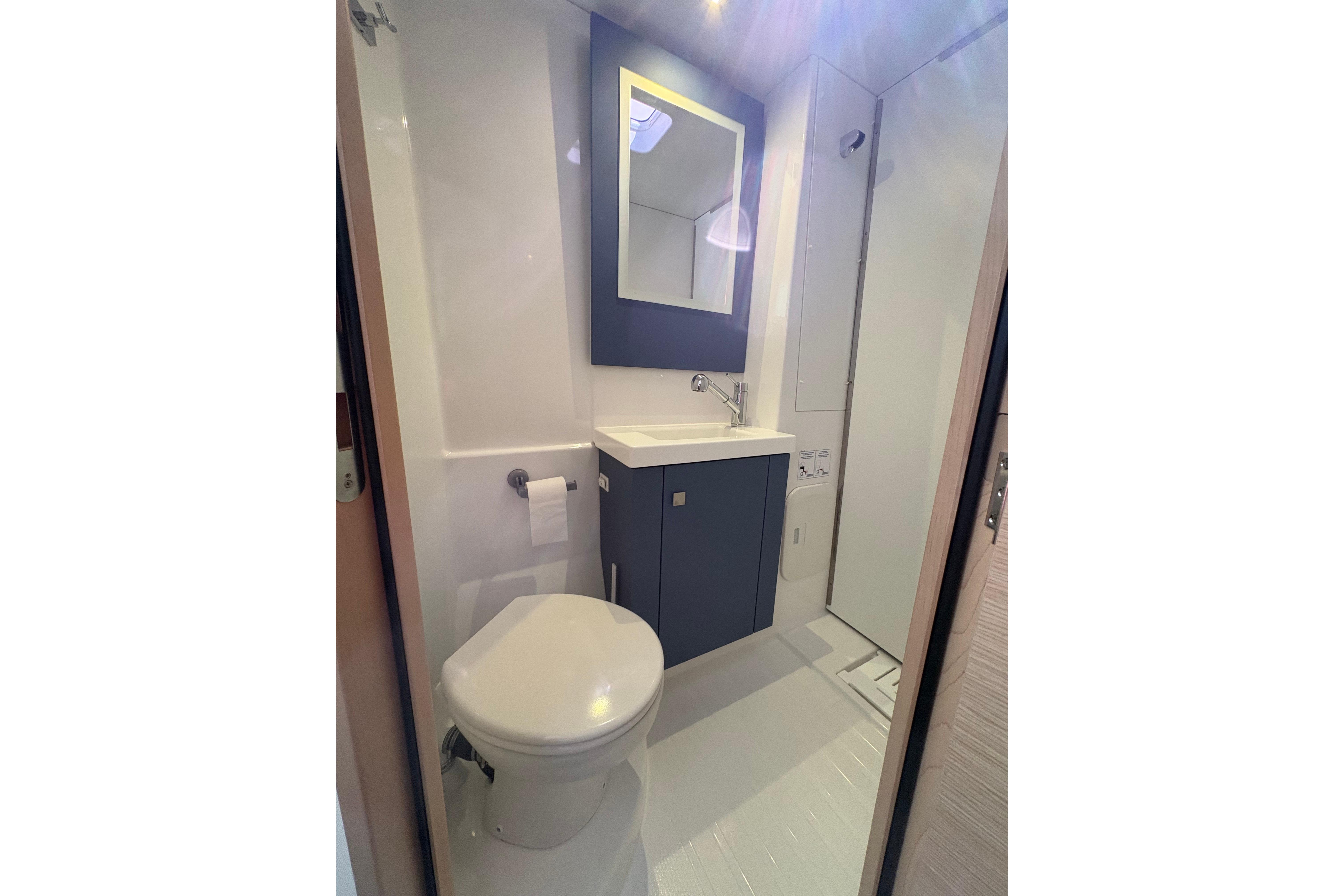 Modern bathroom in 2024 Fountaine Pajot Astrea 42 Catamaran, featuring sleek fixtures and cabinetry.