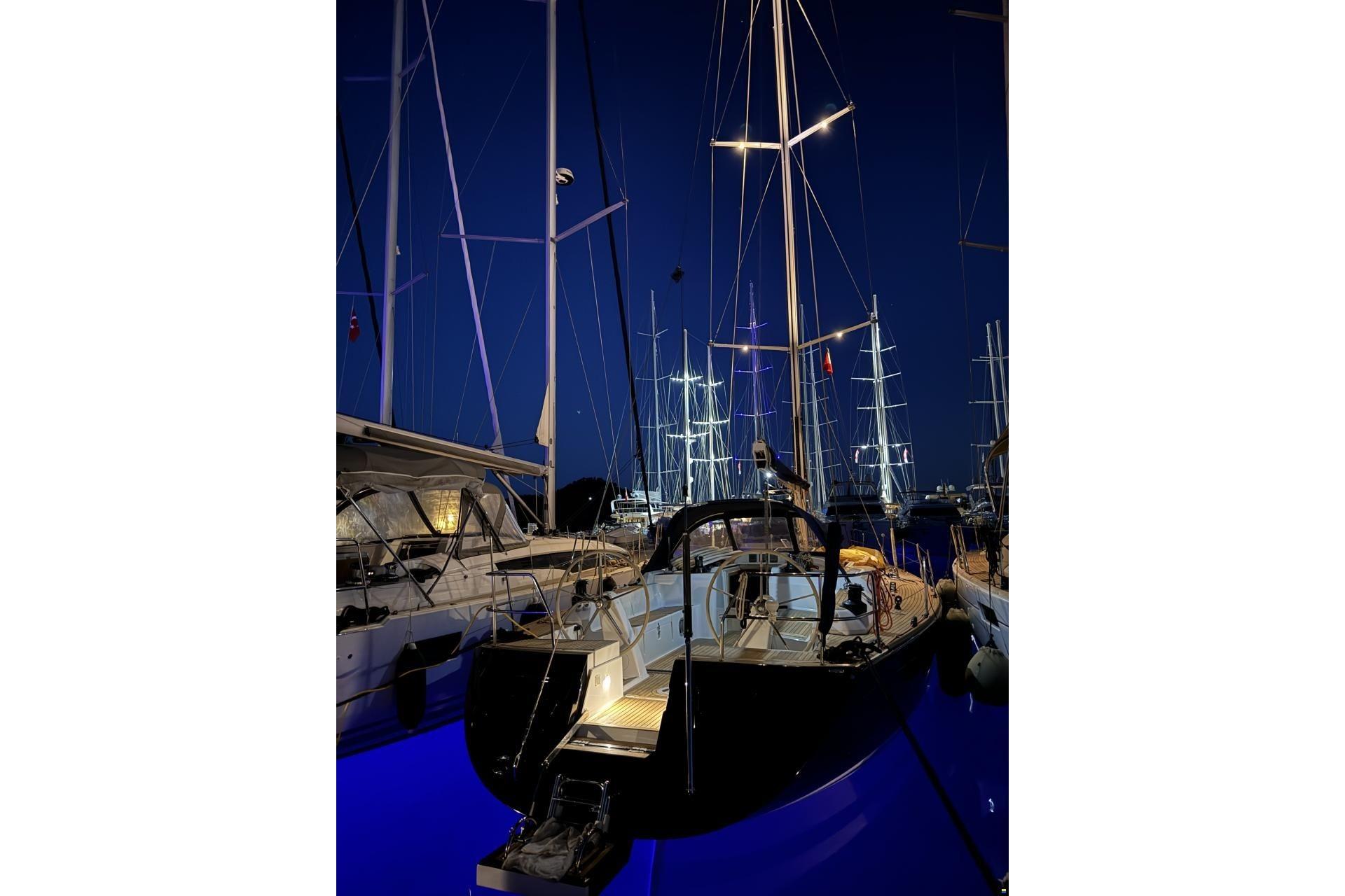 Grand Soleil 50 yacht, 2006 model, docked at night with illuminated masts.