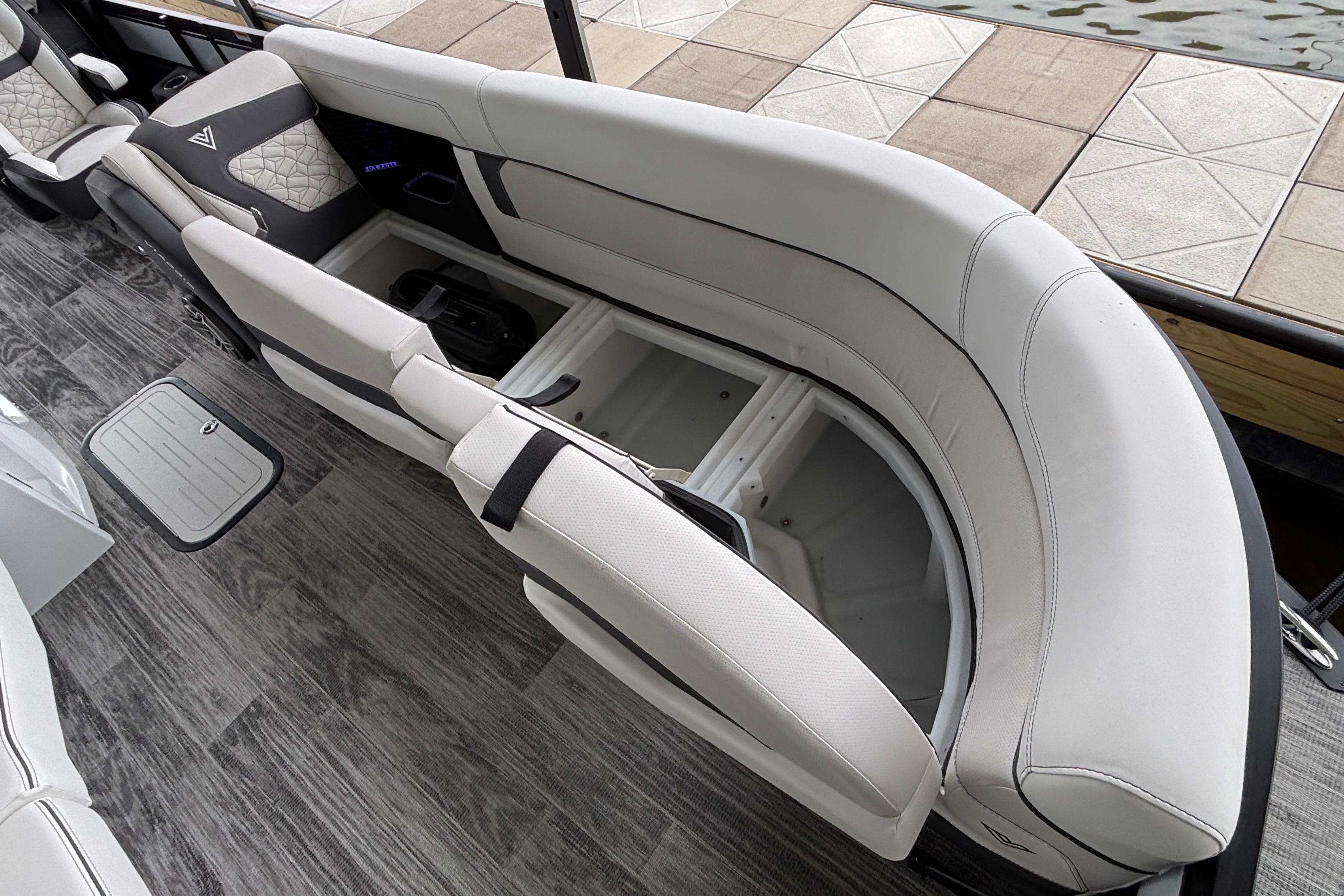 Luxurious seating on 2026 Viaggio D26U boat with storage compartment open.