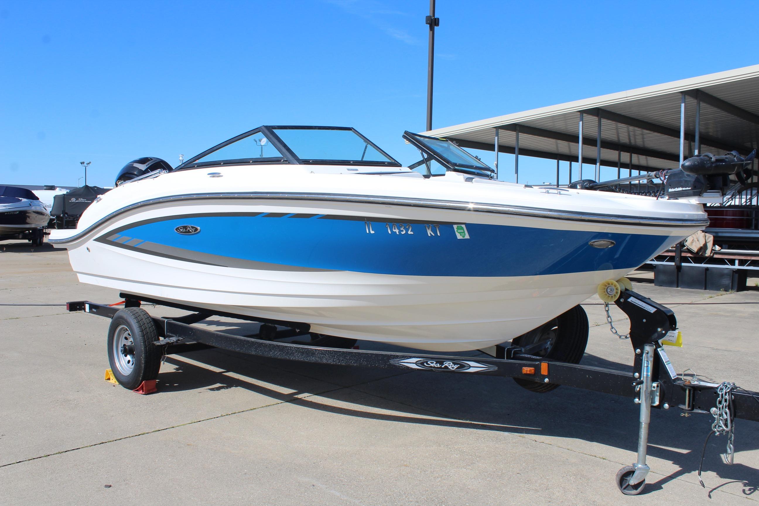 2015 Sea Ray 19 SPX OB boat on trailer, blue and white design, parked outdoors.