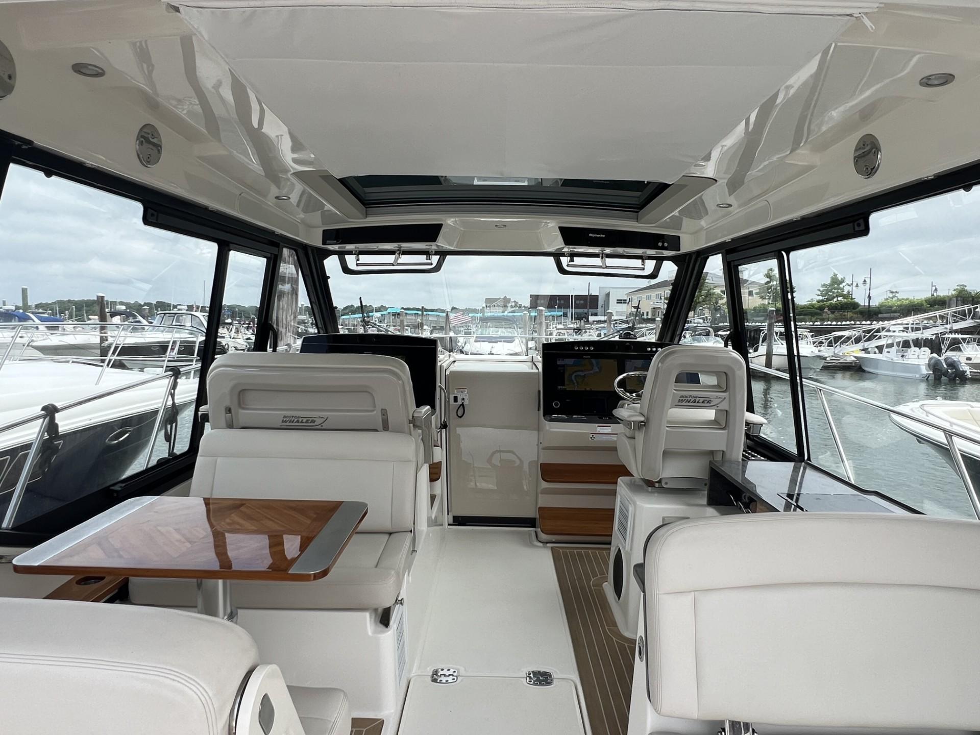 Interior of 2021 Boston Whaler 405 Conquest yacht, featuring luxurious seating and helm.
