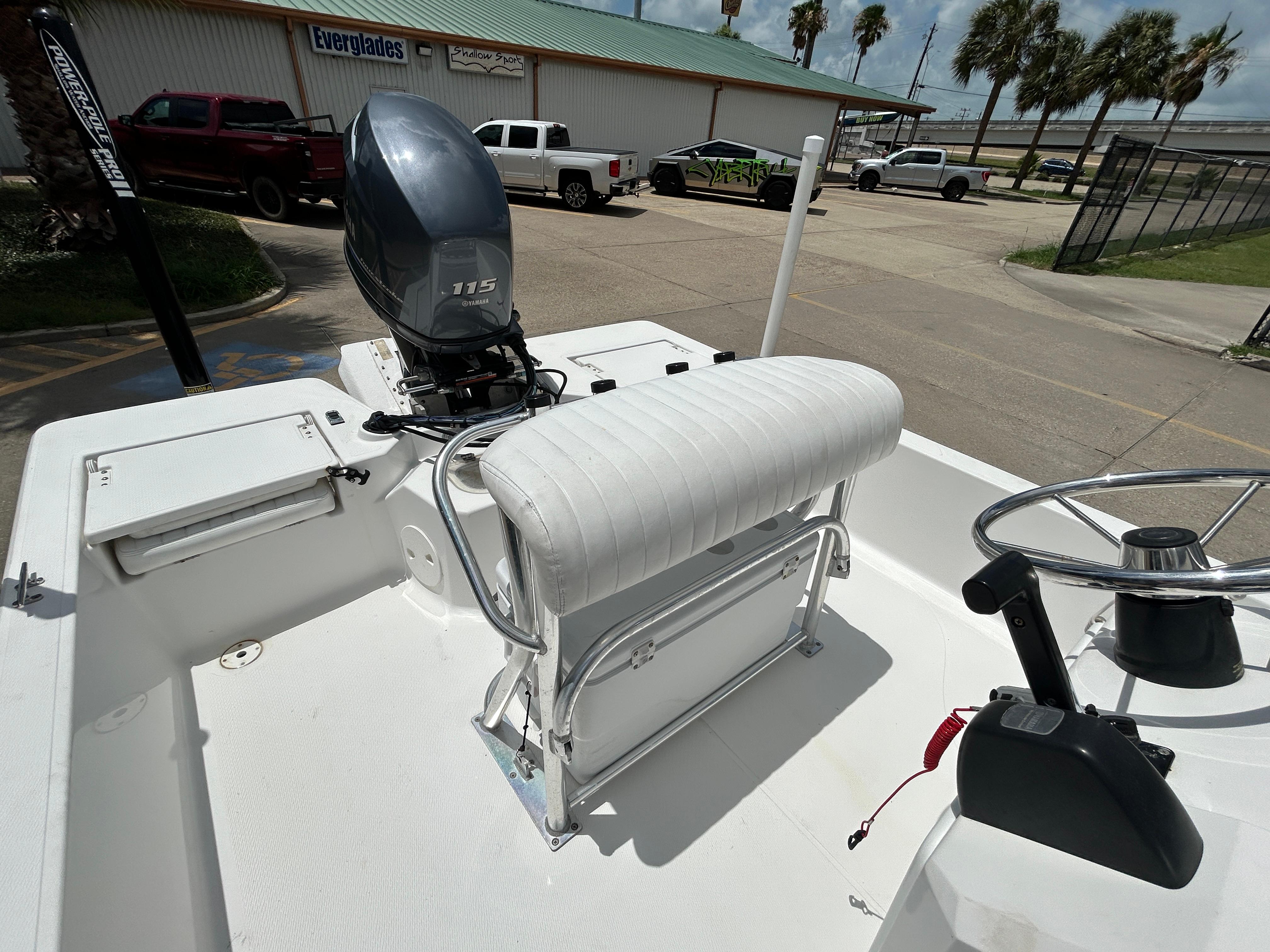 2012 Blue Wave 1900 STL boat with Yamaha 115 engine, parked near Everglades building.