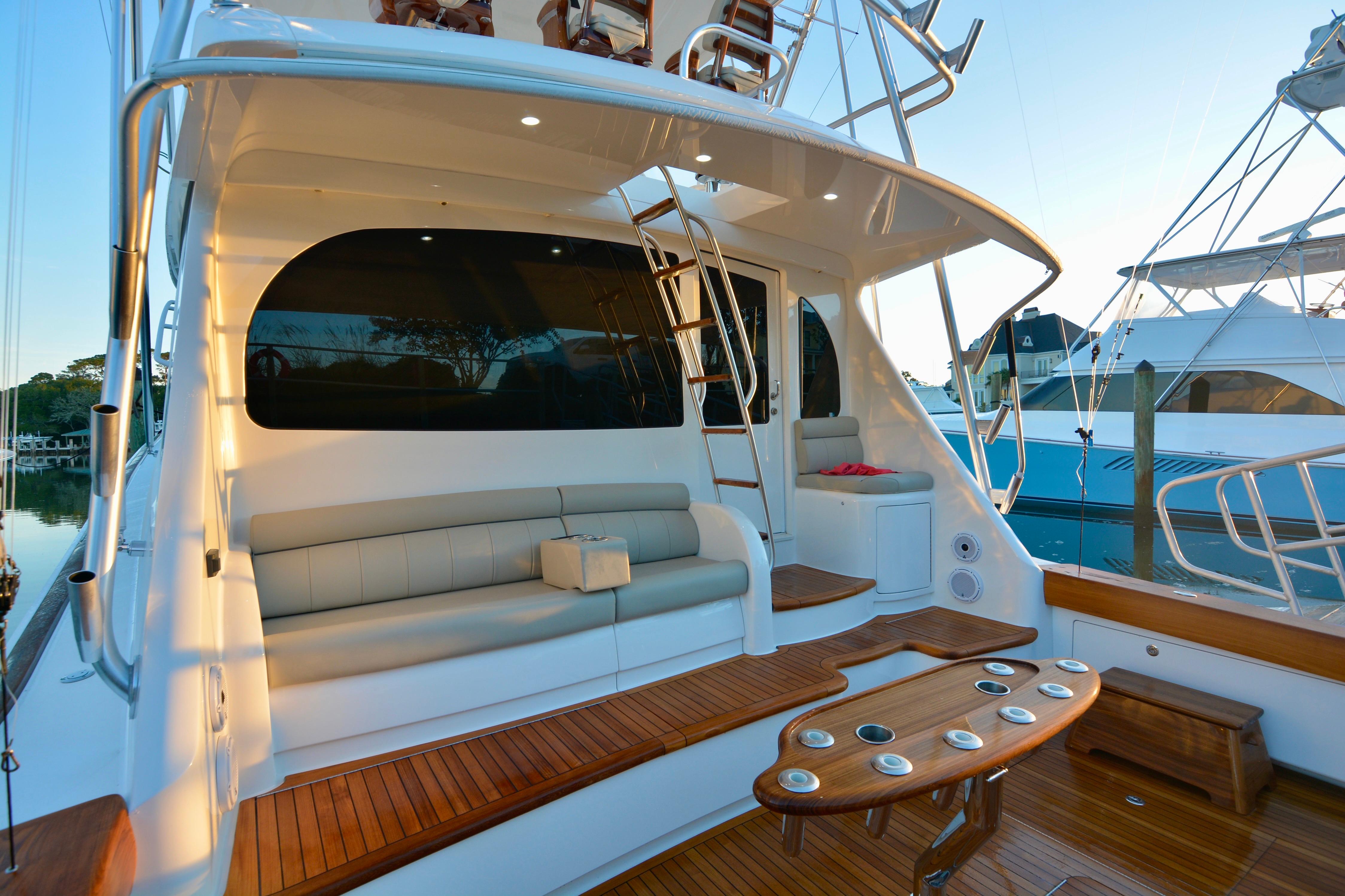 2019 Viking 68 Convertible yacht with elegant seating and wooden deck.
