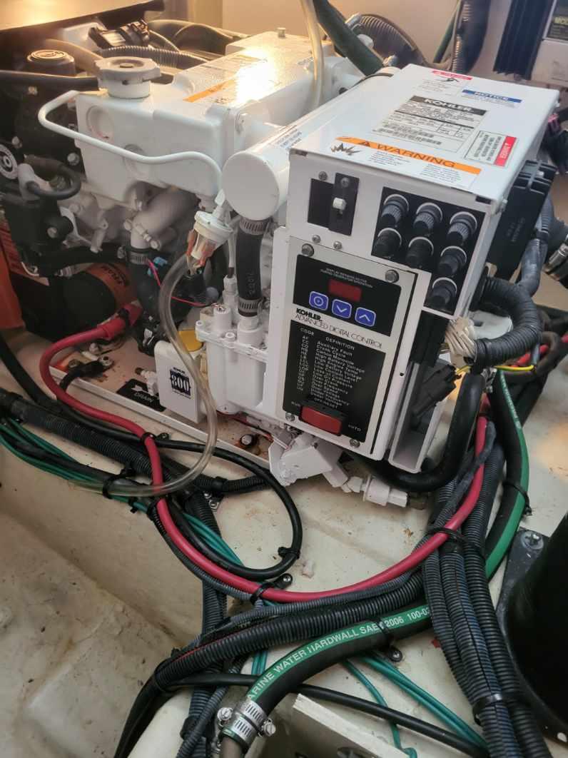 Engine compartment of a 2009 Sea Ray 310 Sundancer with wiring and control panel.