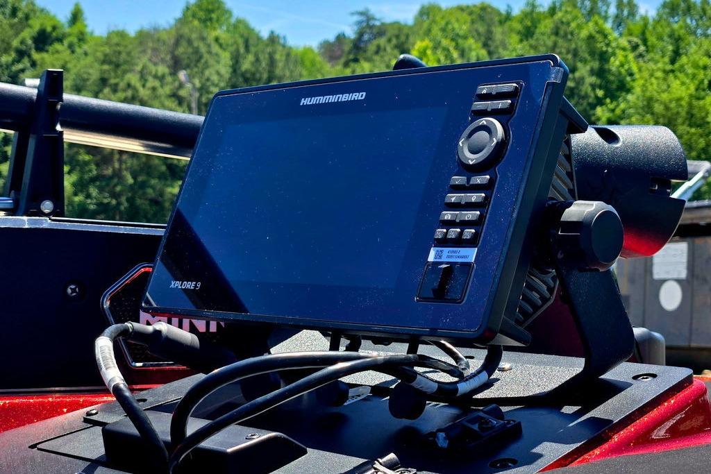 Humminbird Xplore 9 fish finder on 2026 Skeeter ZXE20 boat, surrounded by lush greenery.