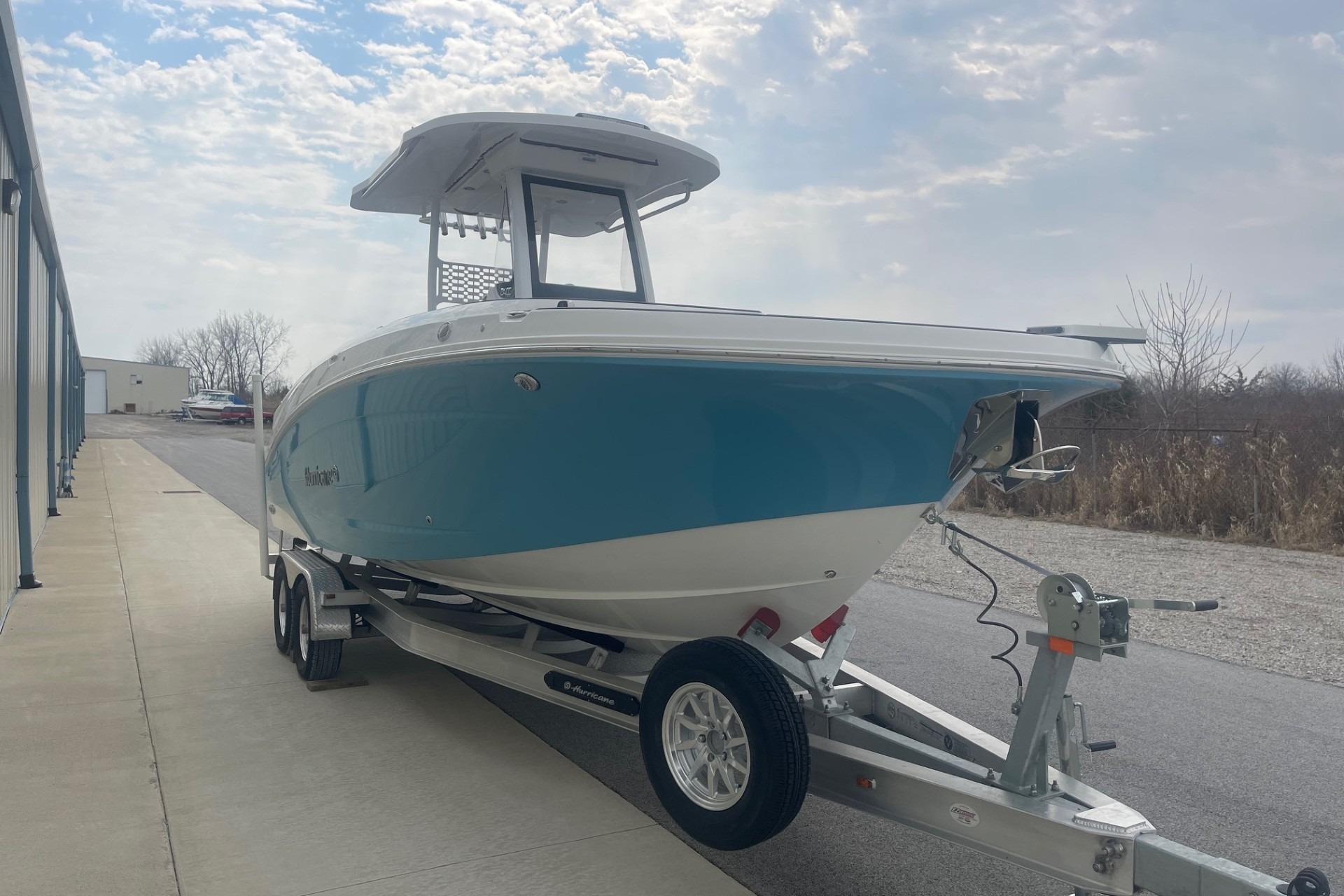 2025 Hurricane Center Console 24 OB boat on trailer, parked outdoors under cloudy sky.